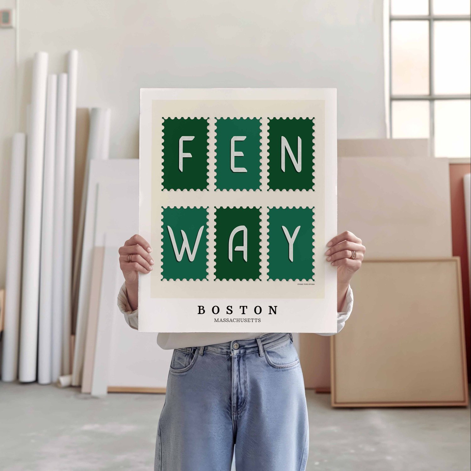 A person holding a poster of several postage stamps