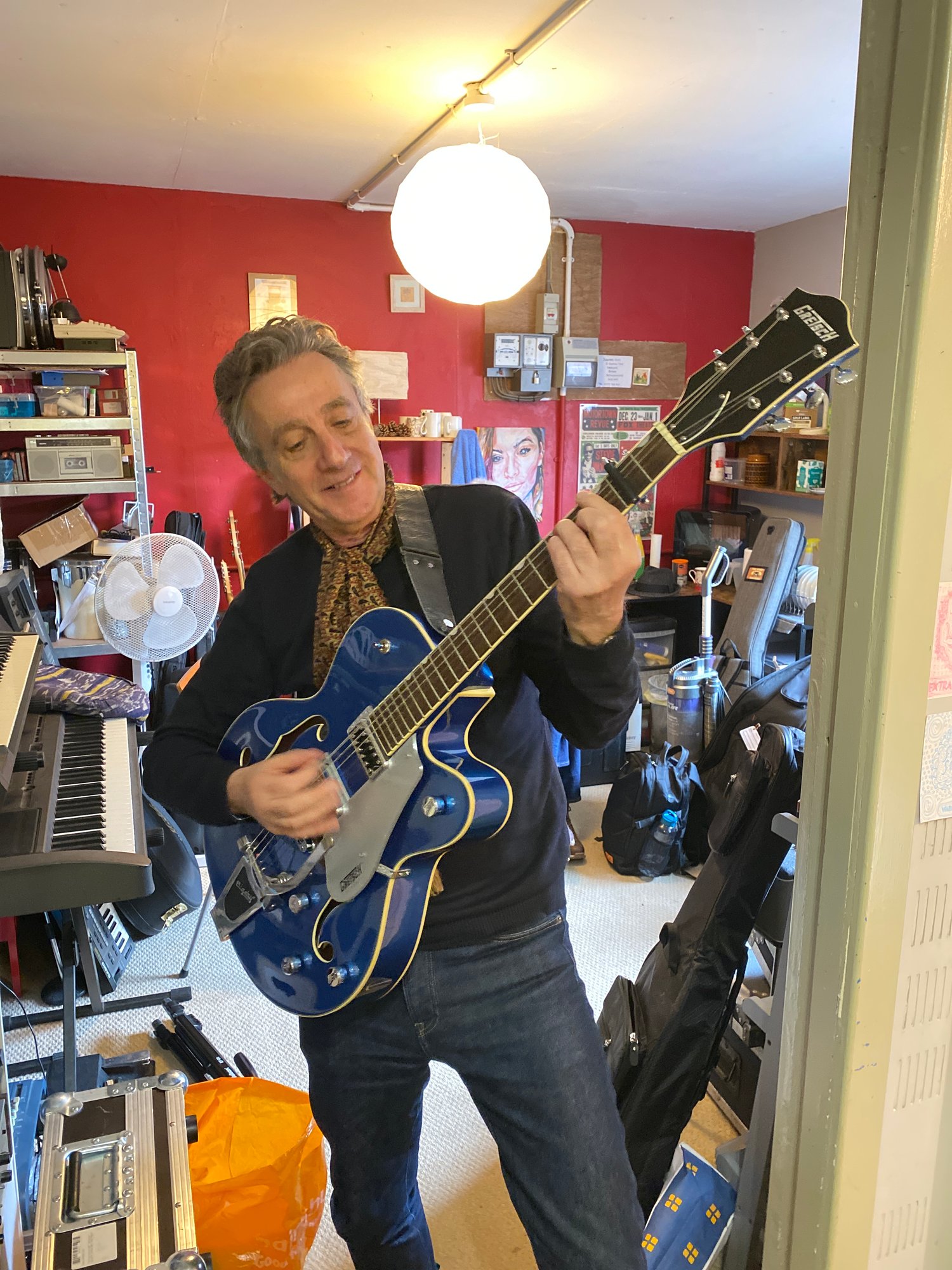 a photograph of gordon russel playing a gretsch guitar in blue, getting ready to record the b side more than friends, for the a side of walk with me single by dave wells, raising money for parkinsons UK