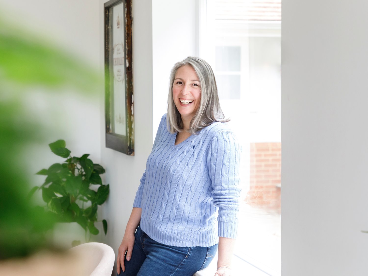 Janet Padfield a nutritional therapist leaning against a ledge