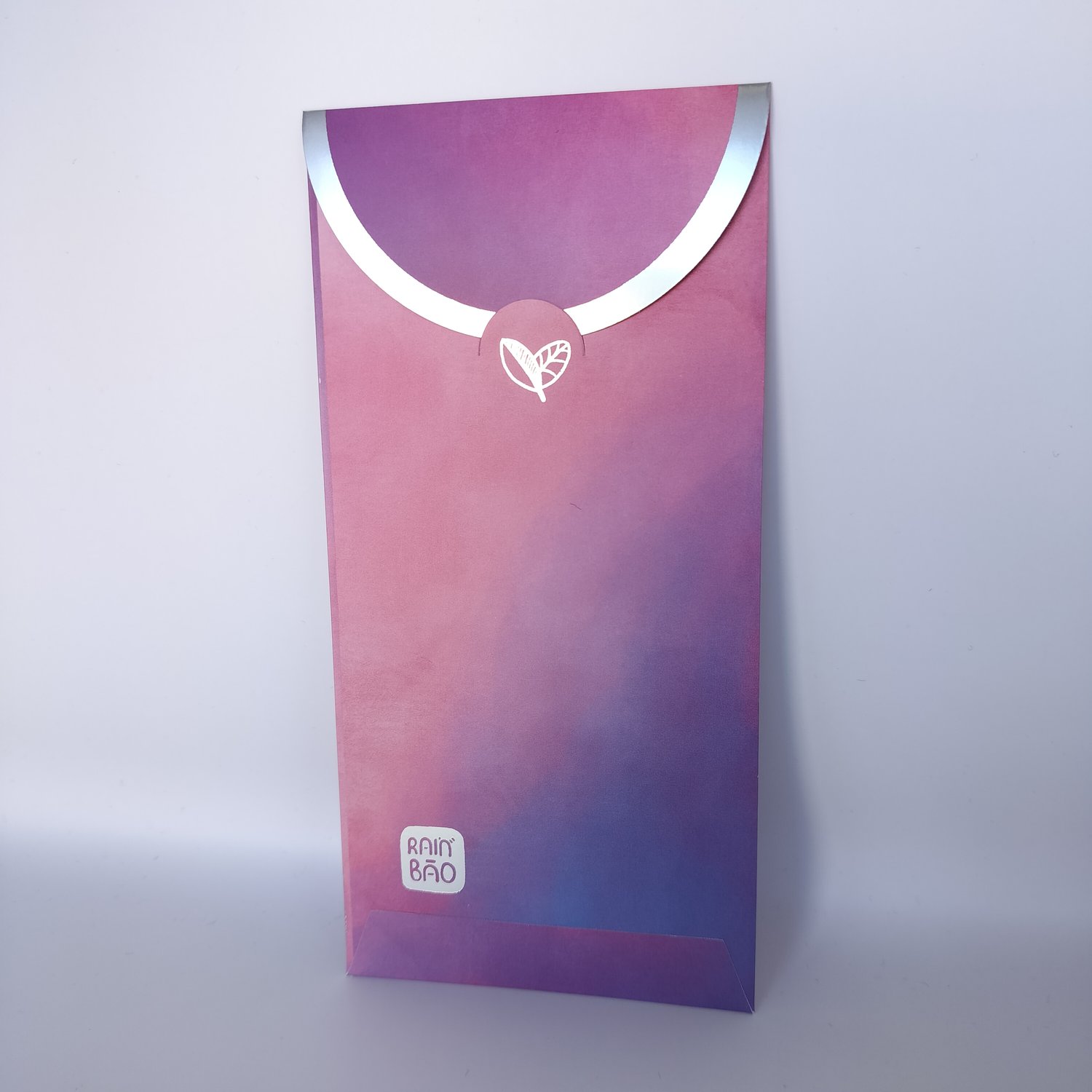 Back of a single pink-to-purple gradient hongbao with silver trim and a logo on the bottom left.