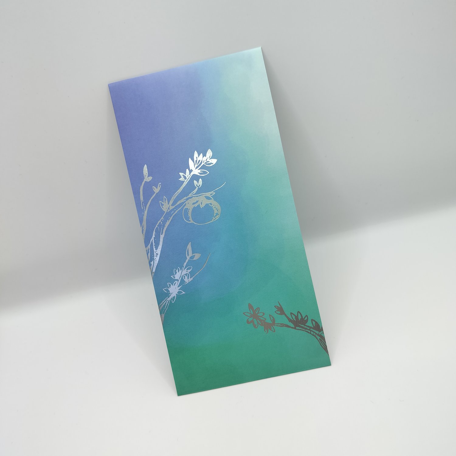 Single blue-to-teal gradient hongbao with silver foil botanical illustrations featuring delicate branches, leaves, and circular vine motifs.