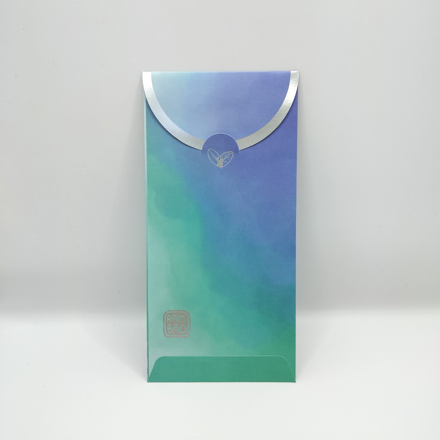 Back of a single blue-to-teal gradient hongbao with silver foil botanical illustrations featuring silver foil trim and a logo on the bottom left.
