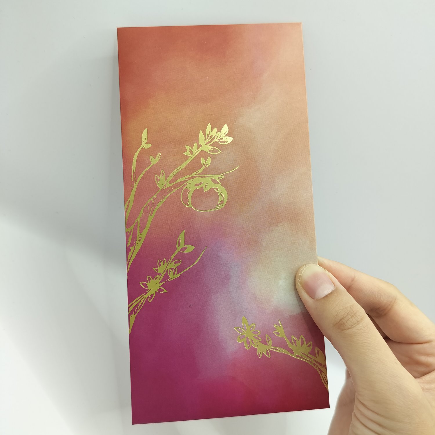 Single red, orange and purple gradient hongbao with gold foil botanical illustrations featuring delicate branches, leaves, and mandarins.