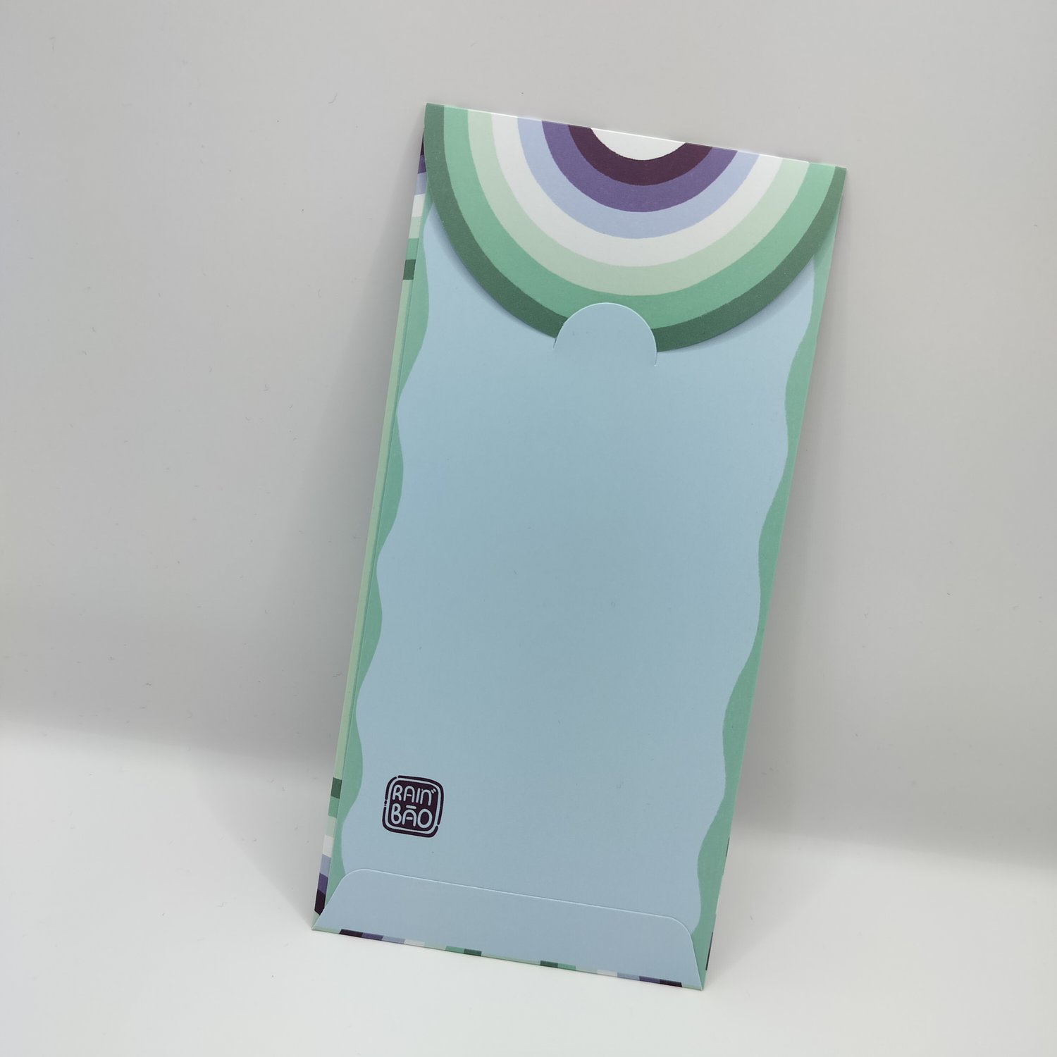 The back of a colorful hongbao with retro rainbow stripe pattern in blue and green tones on the closing flap.