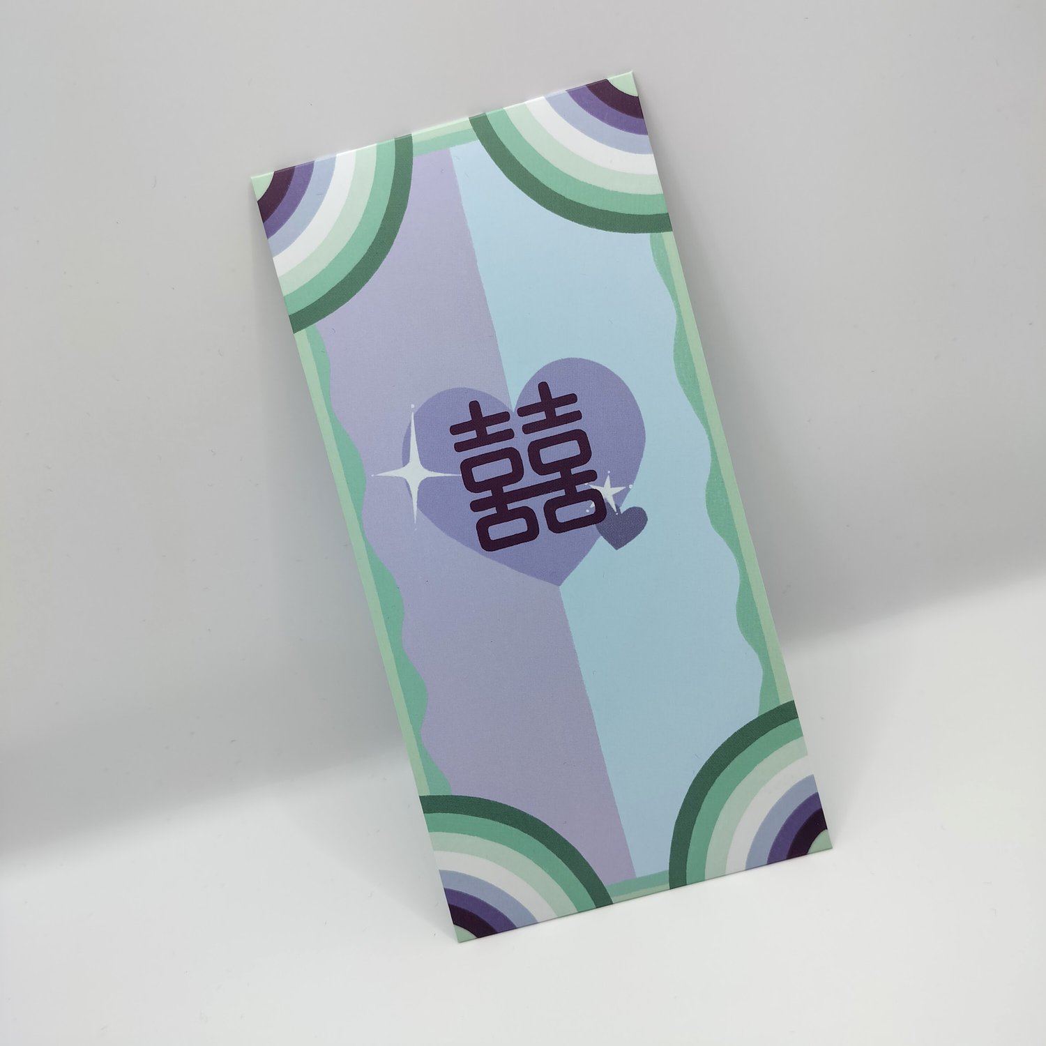 A pastel rainbow envelope with blue double happiness heart