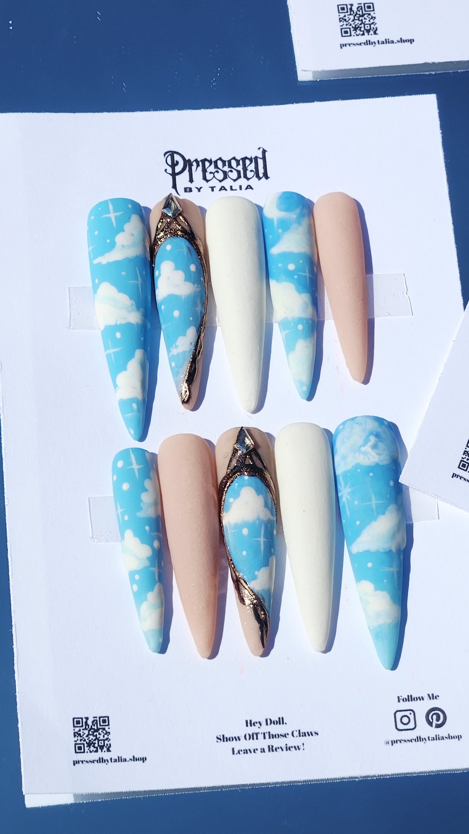 Extra extra long stiletto shaped handmade press-on nails with sky blue and cloud designs, customizable with white and nude acrylic nails, gold chrome baroque style accent press-on nails