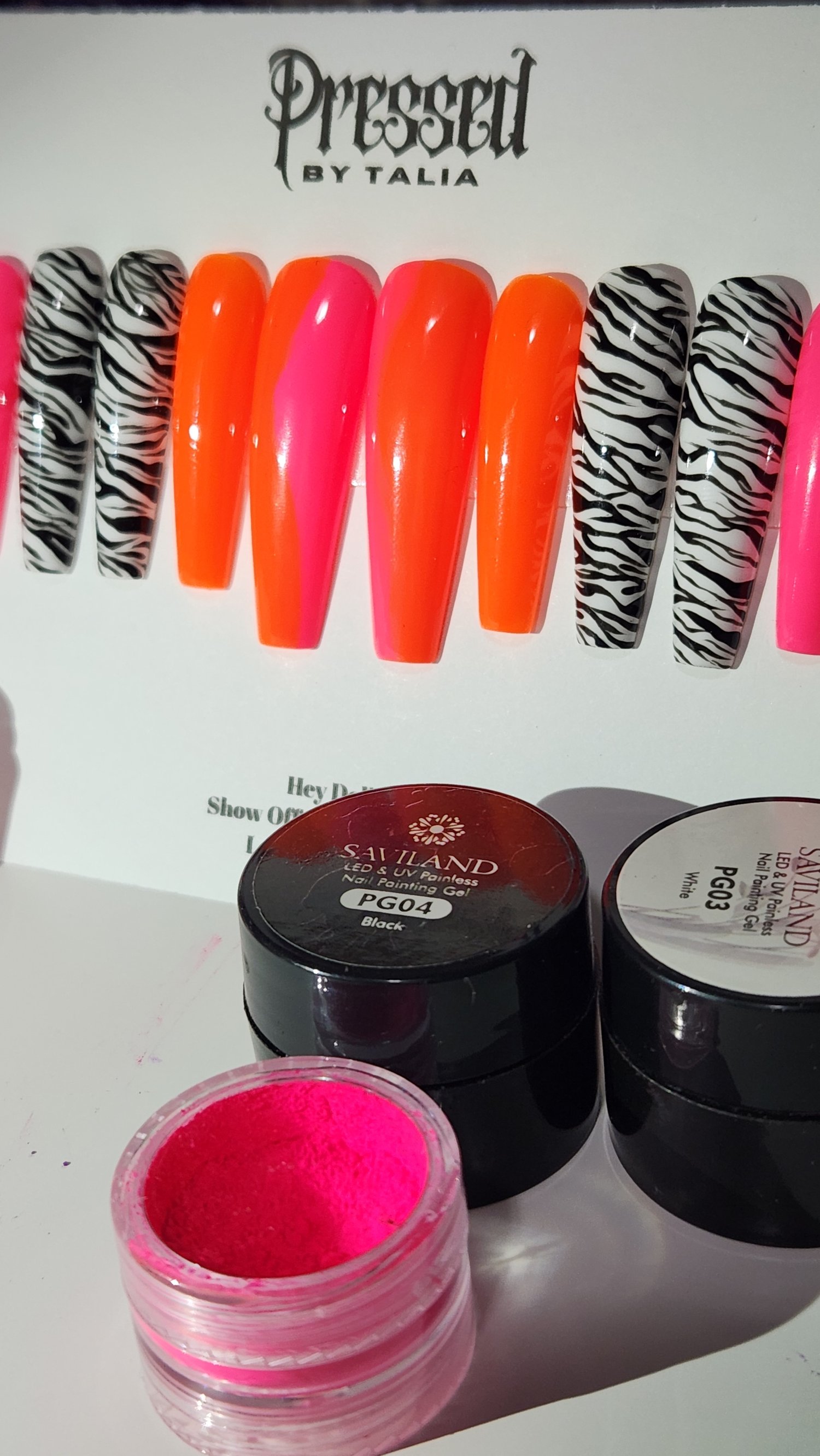 Extra long coffin shaped press-on nails with hot pink and neon orange ombre and handmade zebra printed nails, close-up picture on Pressed By Talia branded card