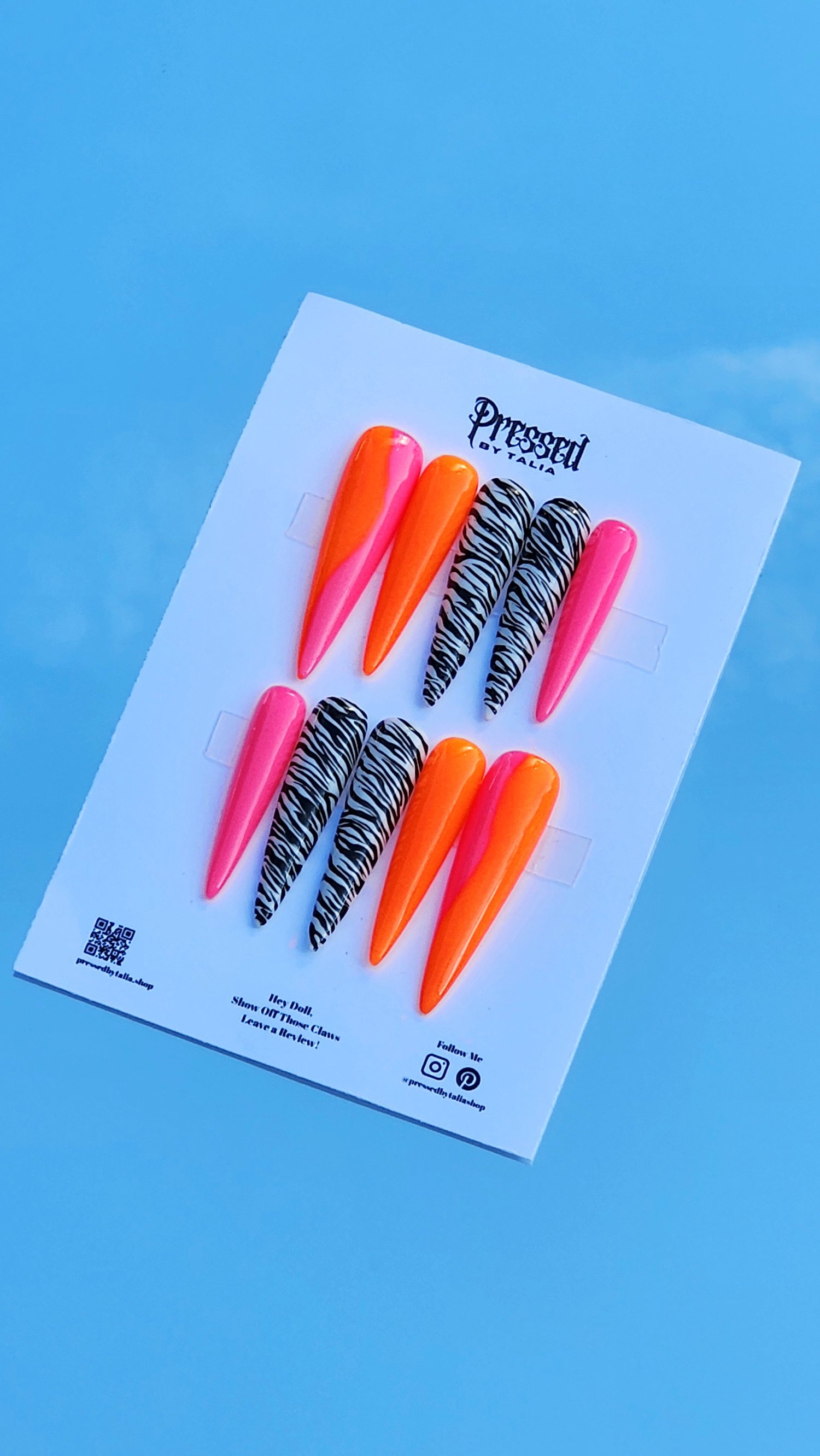 Extra extra long stiletto shaped press-on nails with hot pink and neon orange ombre and handmade zebra printed nails