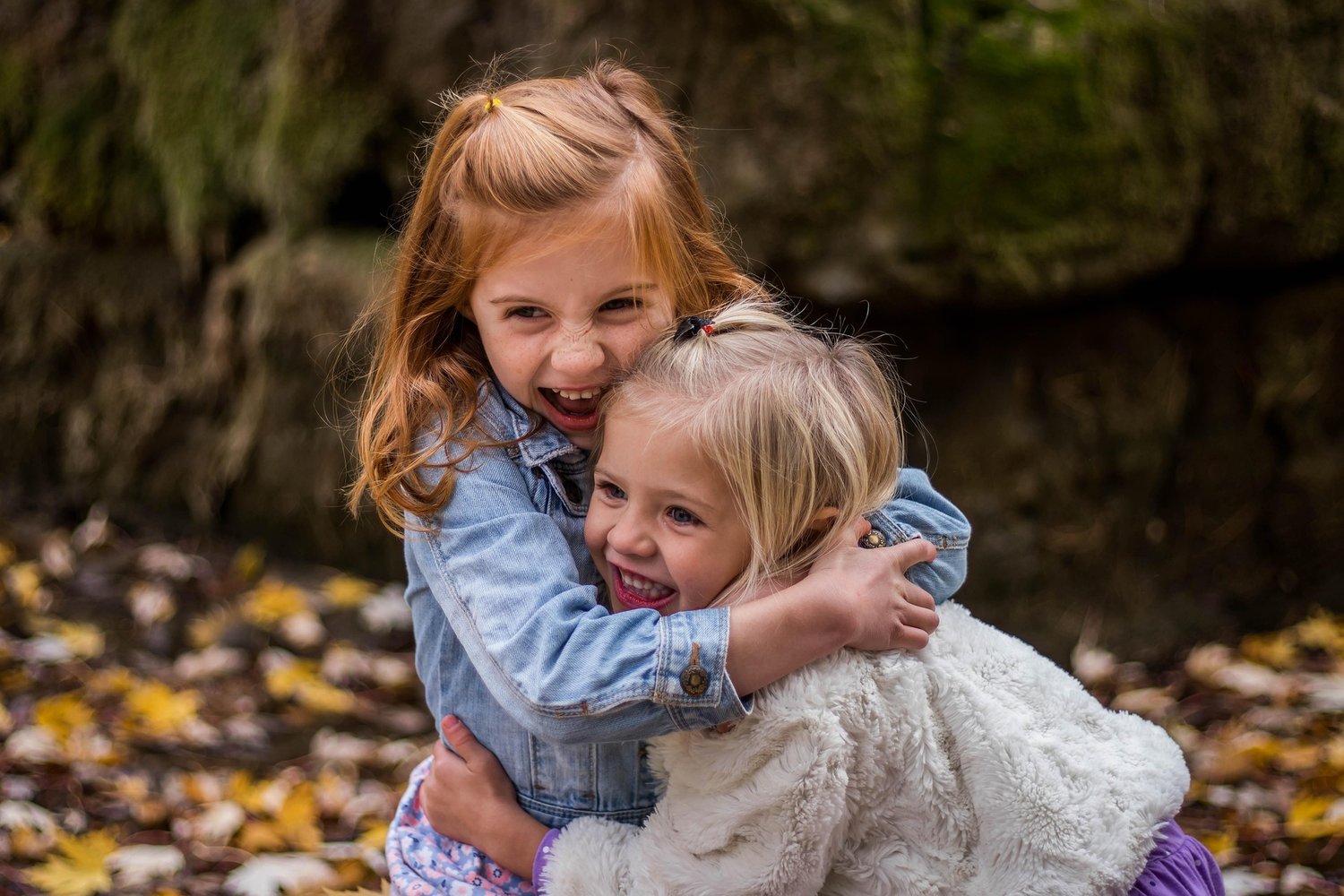 two children playing outside, enjoying each other's company.
