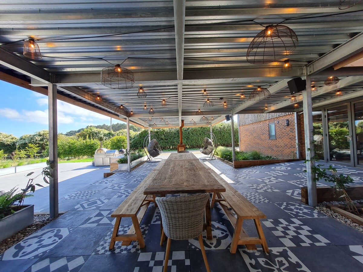 "Charming farmhouse retreat venue in the UK with cozy heated outdoor seating and tranquil views"