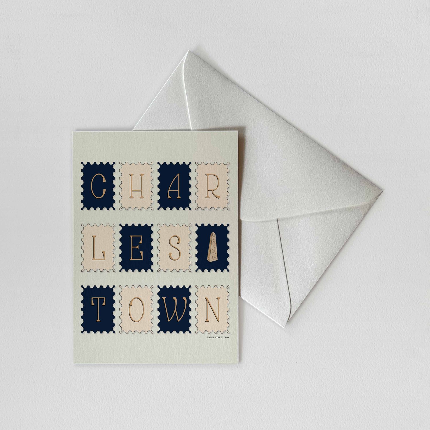 A notecard of postage stamps featuring the Charlestown neighborhood in Boston, Massachusetts drawn in a unique lettering style with a white envelope. Artwork has a navy blue, beige and tan color scheme