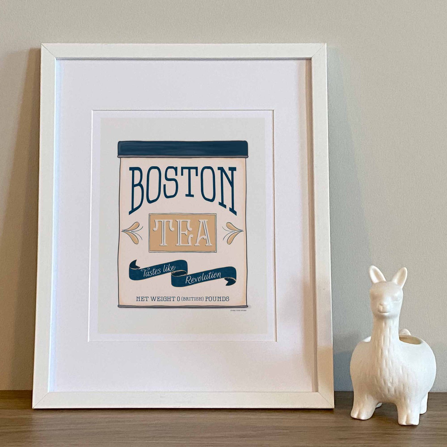Nautical-style Boston wall art featuring a vintage tea tin design with the phrase ‘Tastes Like Revolution.’