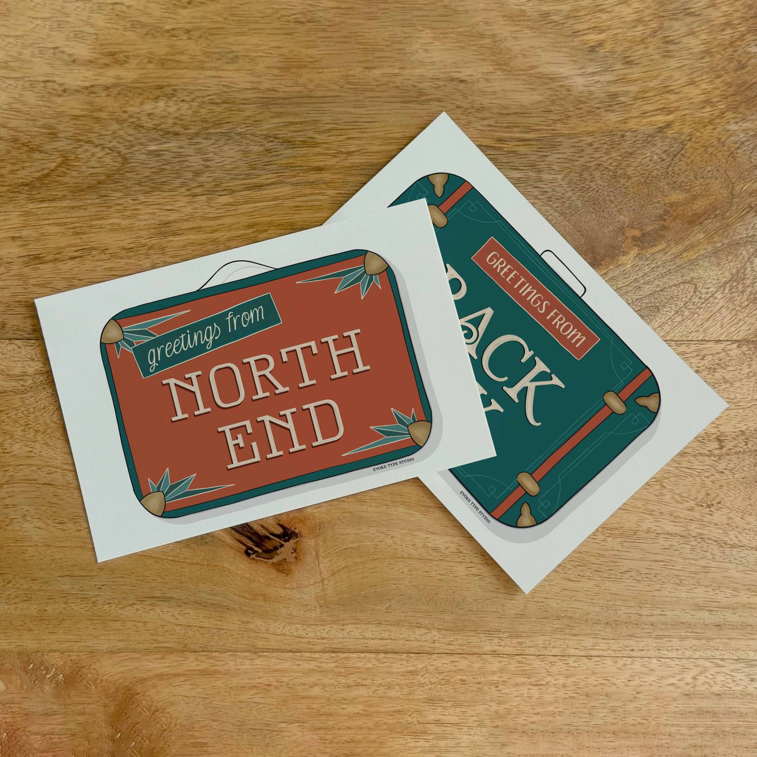 Two postcards, one placed on top of the other. Both postcards feature vintage suitcase illustrations and are for neighborhoods in the Boston, Massachusetts area.