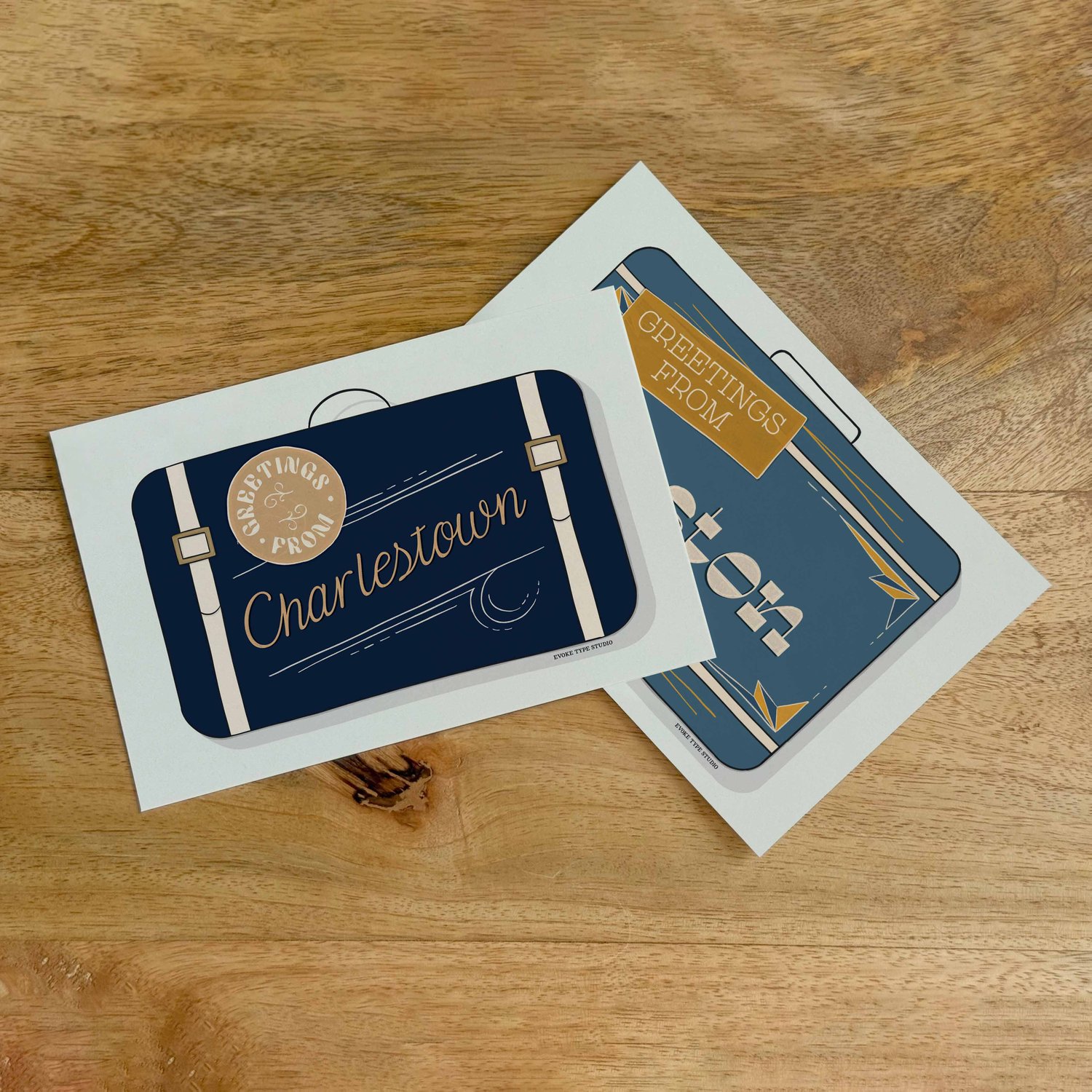 Two postcards, one placed on top of the other. Both postcards feature vintage suitcase illustrations and are for the Boston, Massachusetts area.