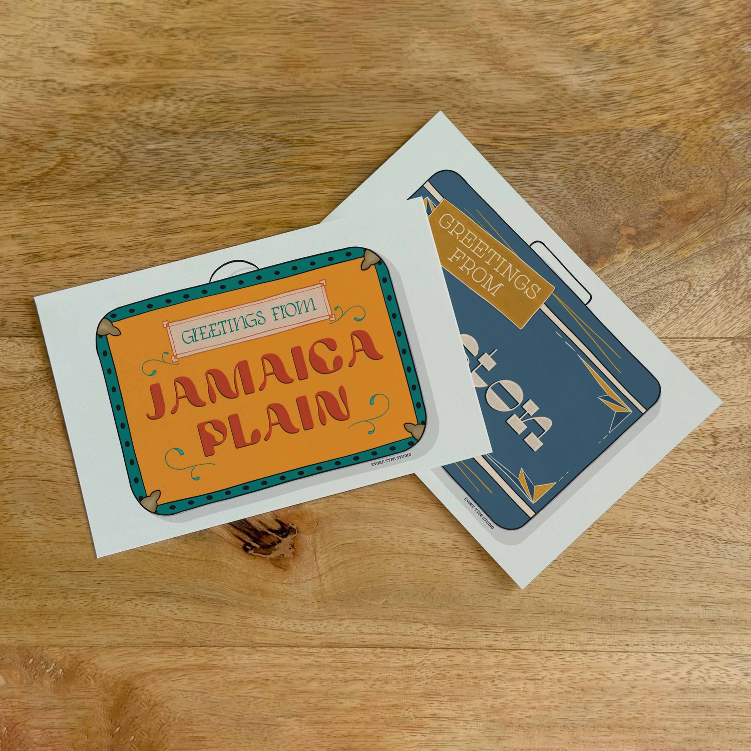Two postcards, one placed on top of the other. Both postcards feature vintage suitcase illustrations and are for the Boston, Massachusetts area.
