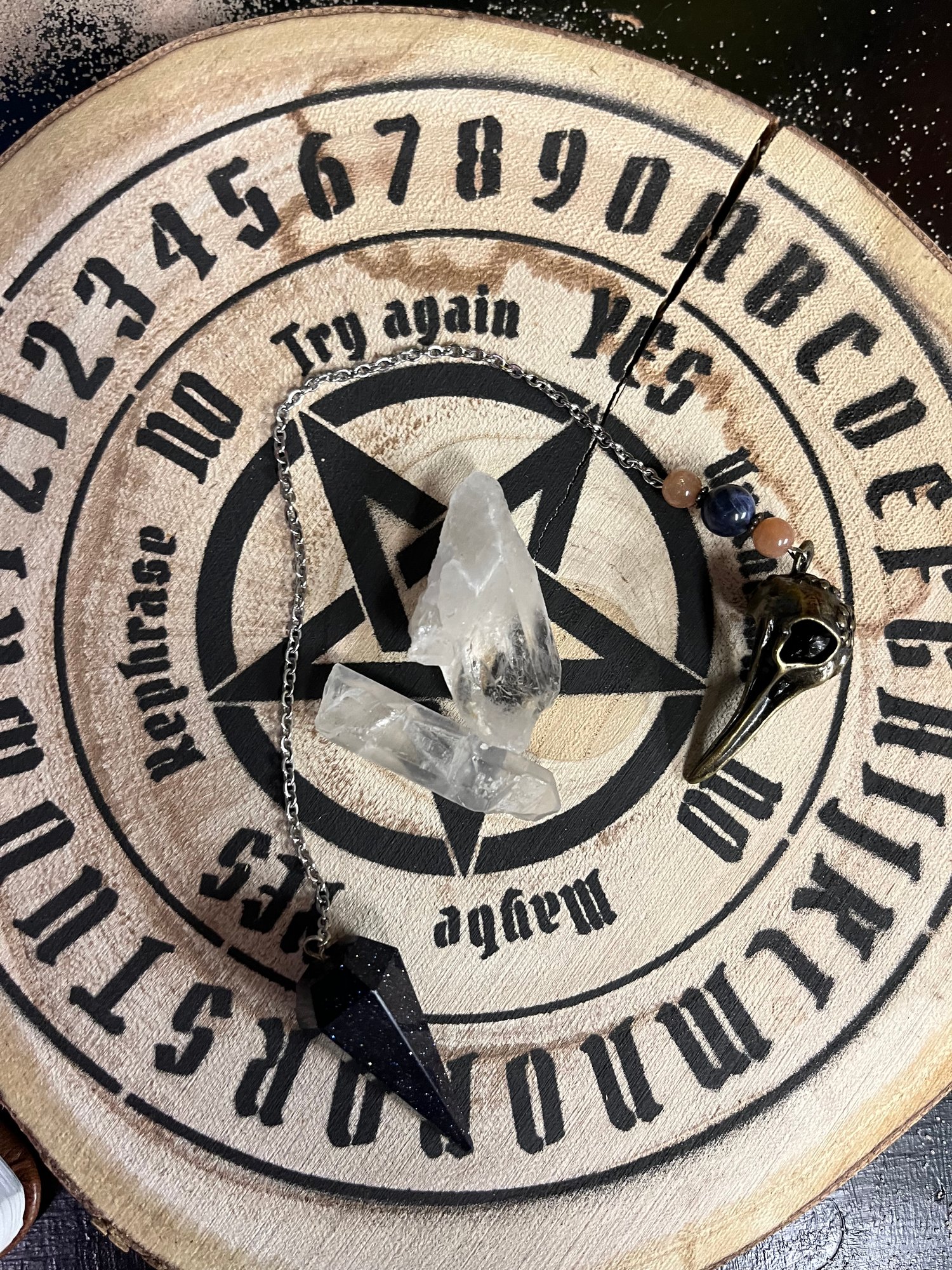 Pendulum board quartz crystal and pendulum on my altar