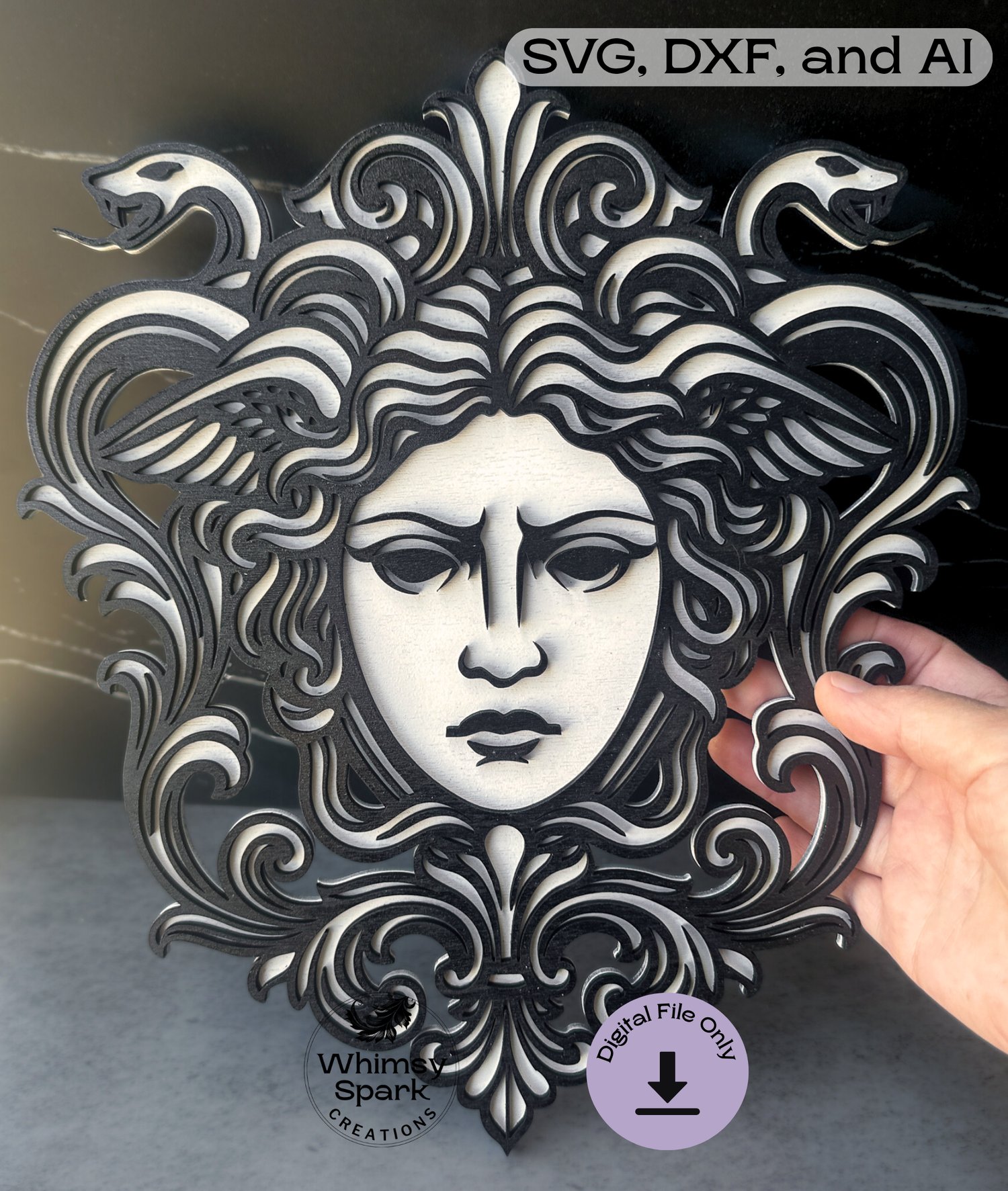 Baroque-style Medusa laser cut design held in hand, showing intricate snake hair details