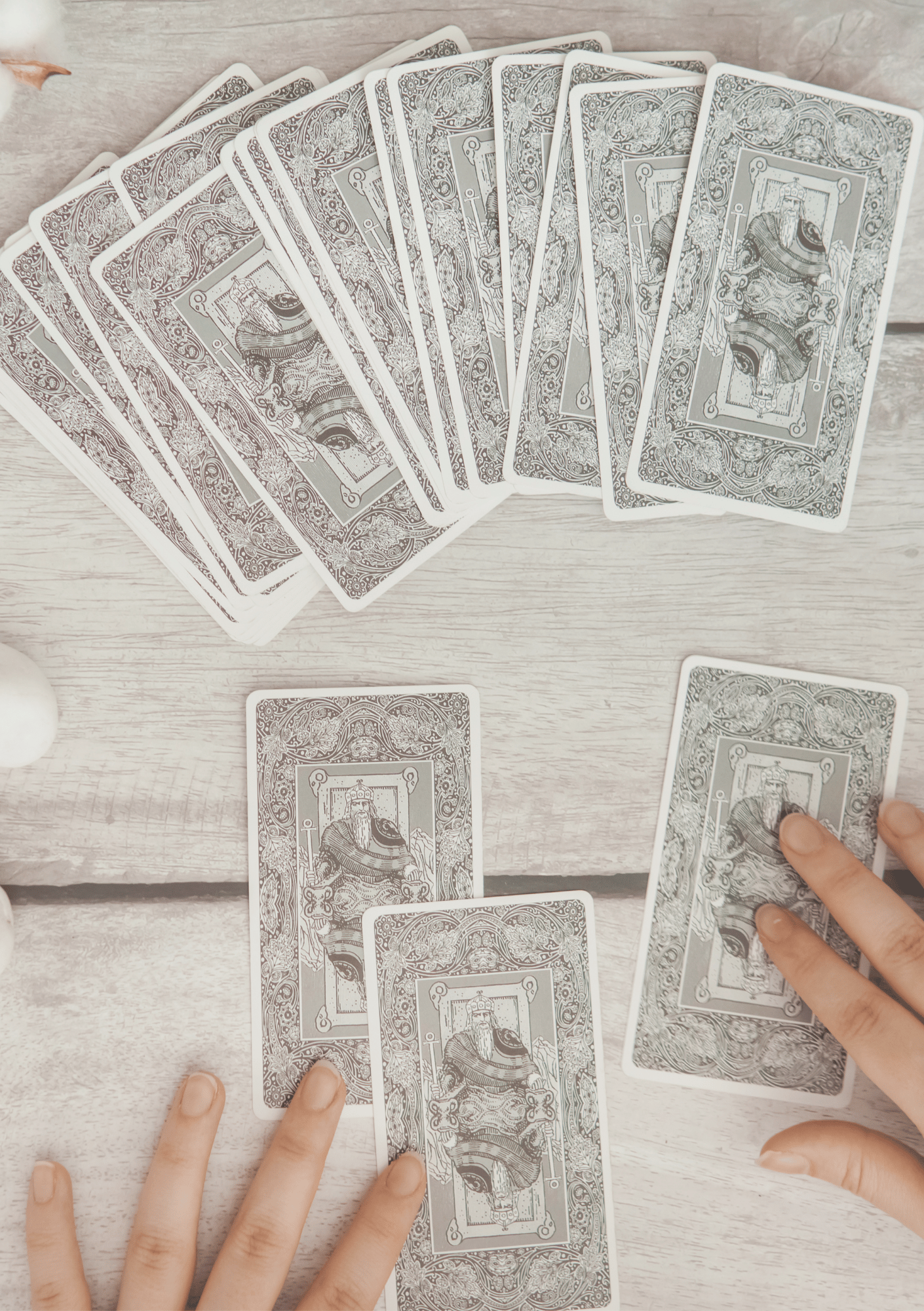 Hands laying out tarot cards on a wooden table during a reading — image for Intuitive Tarot Readings page on iamisabelbar.com