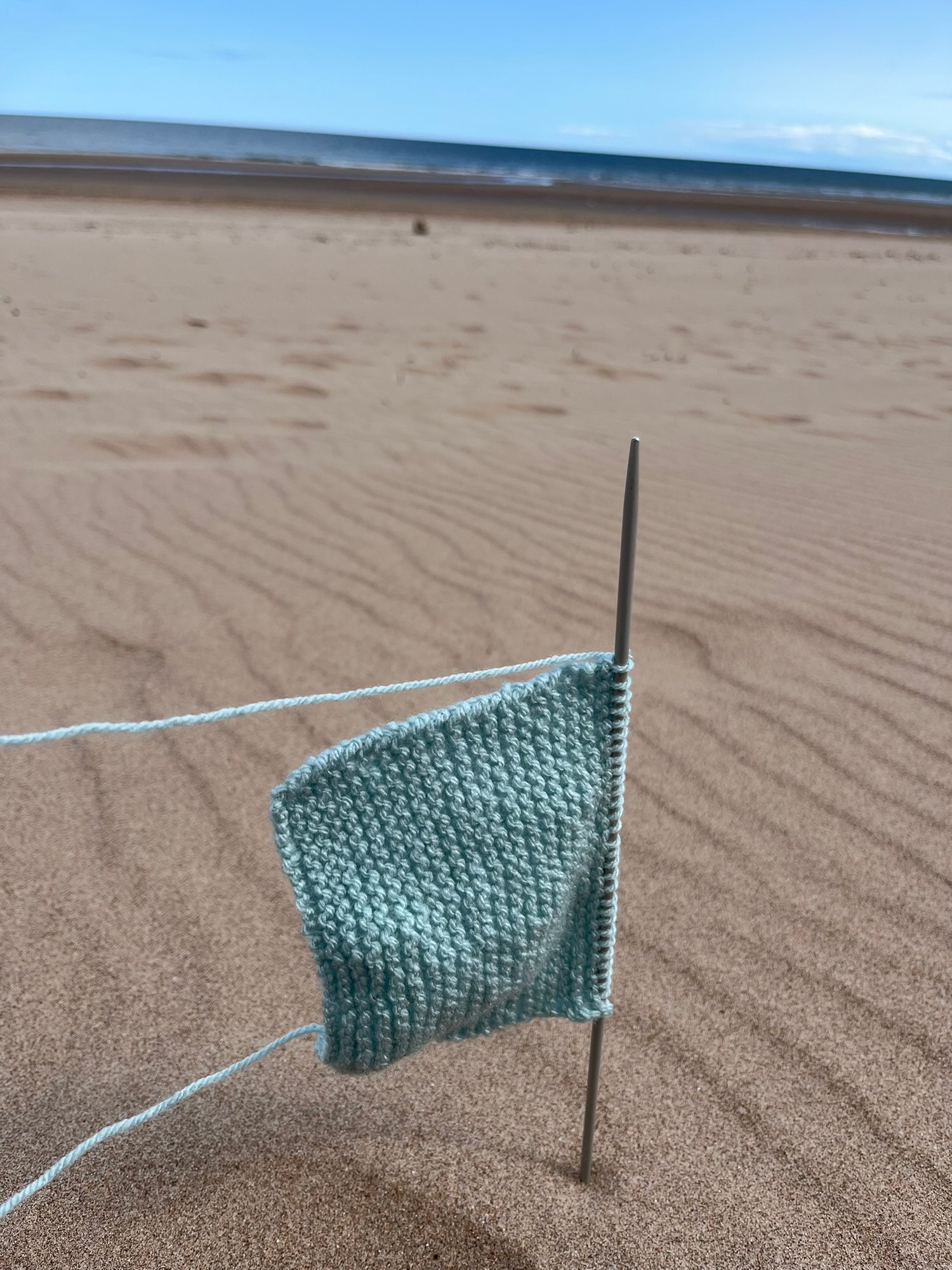 Garter Stitch Swatch being knitting on the beach, flying like a flag