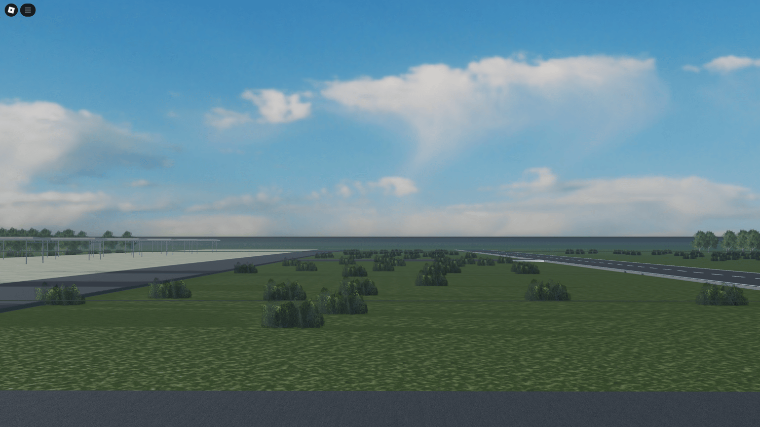 Sheds beside airstrip surrounded by trees