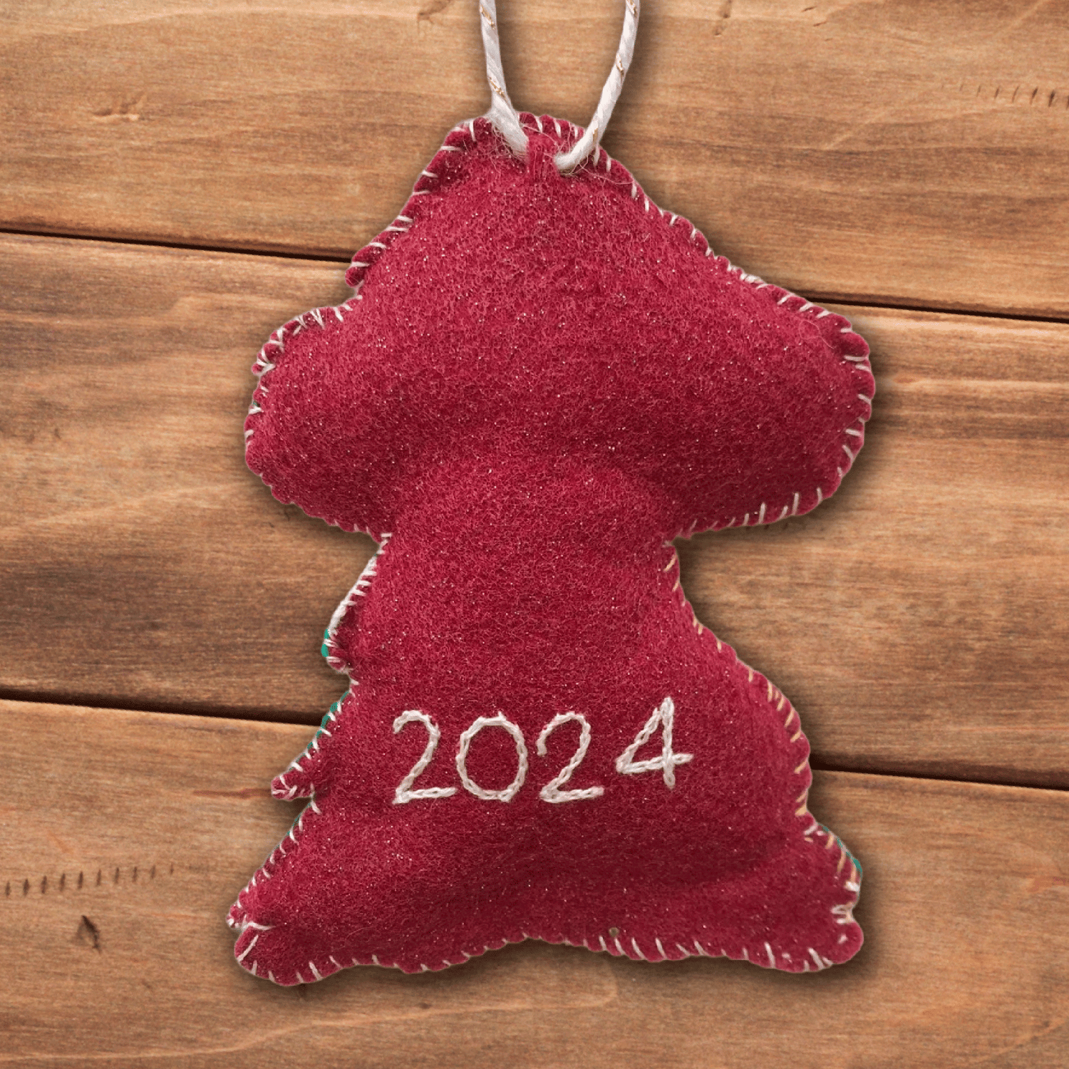 The back of the ornament showing the year "2024" embroidered on the felt.