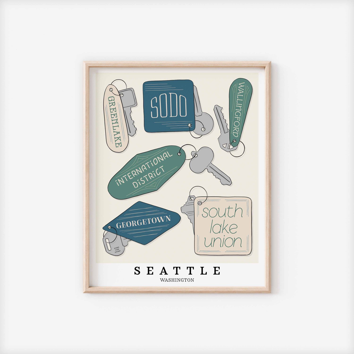 A framed picture of Seattle, Washington neighborhoods drawn in various lettering styles on key fobs. Artwork has a blue, green and beige color scheme