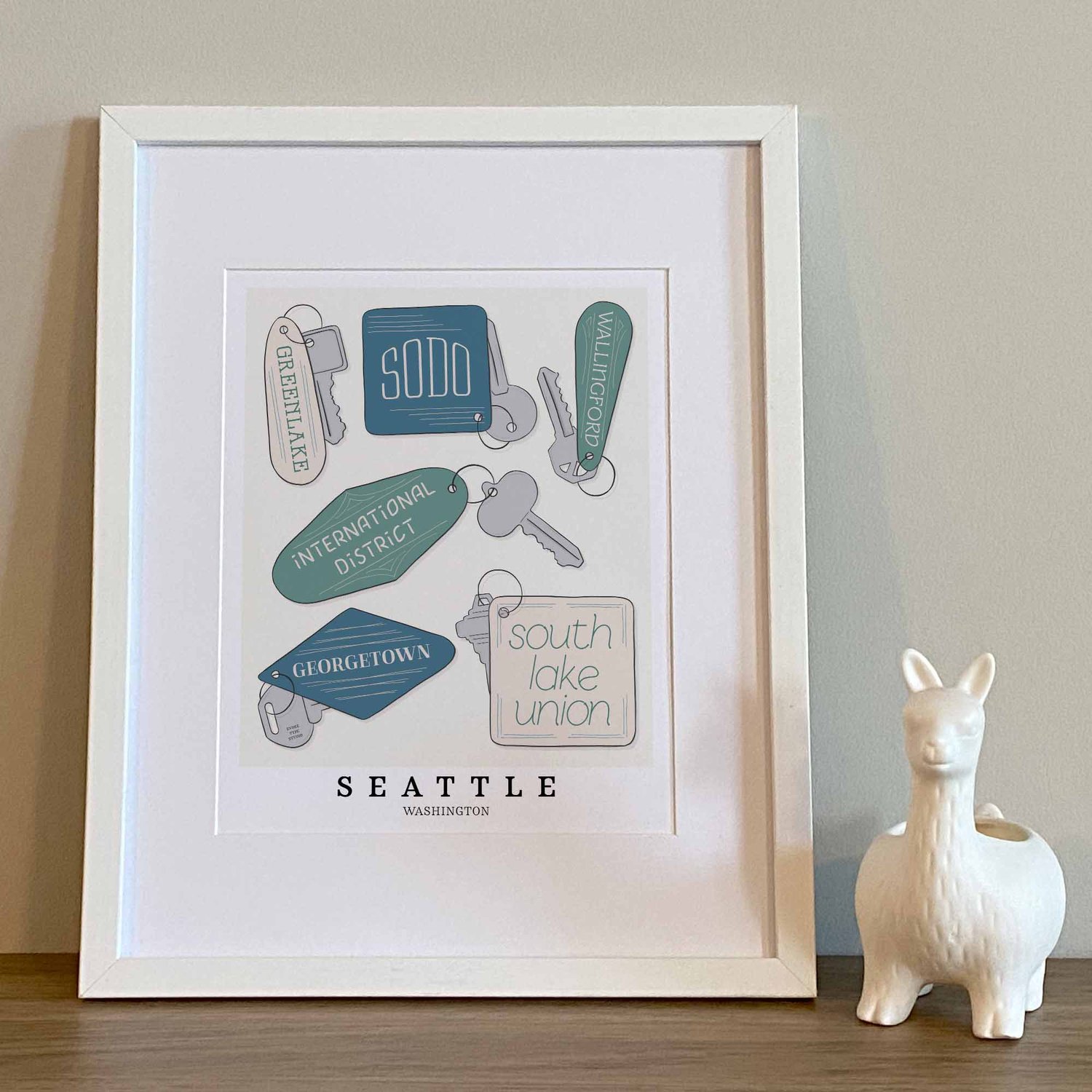 Seattle neighborhoods depicted in playful, hand-lettered key fobs with coastal-inspired colors