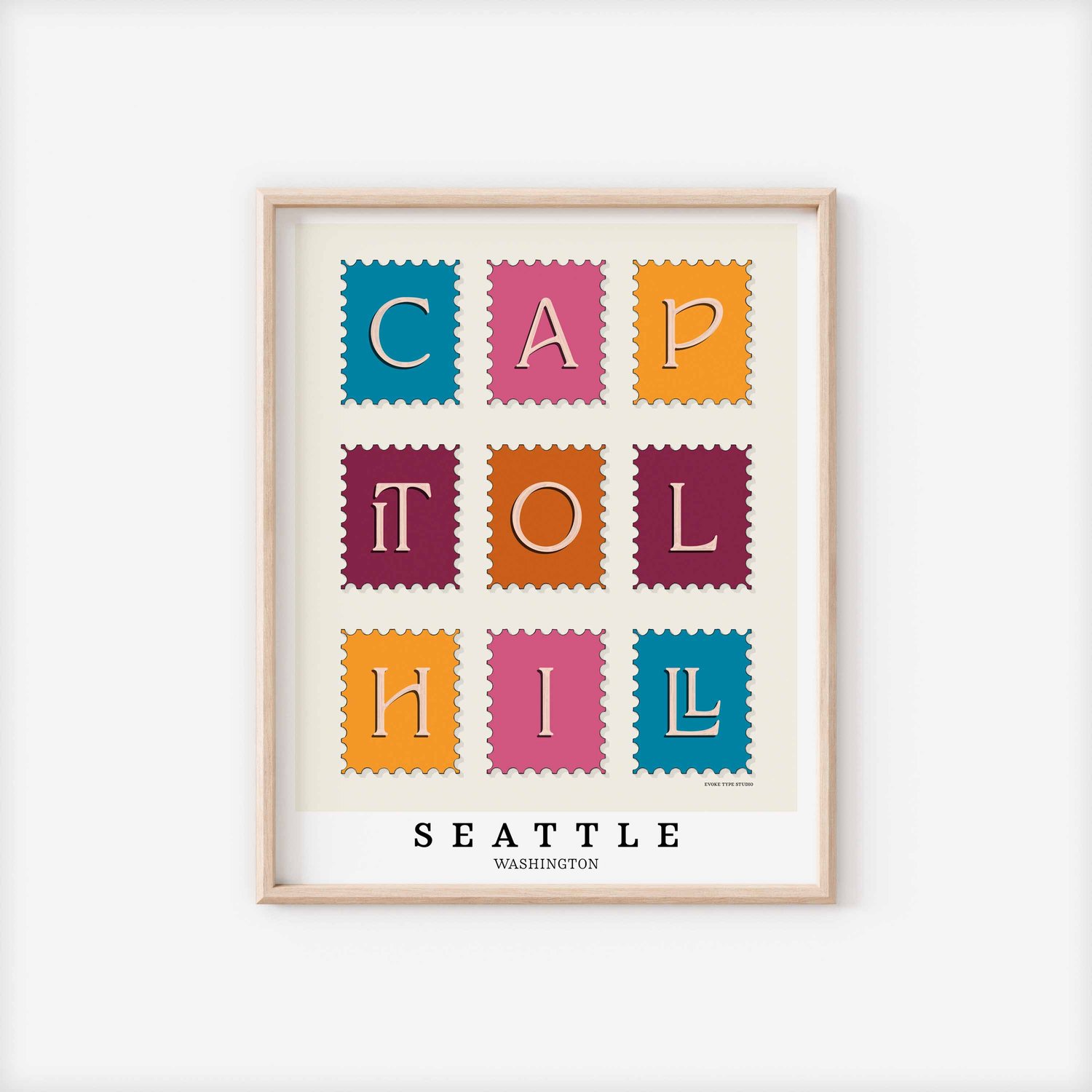 A framed picture of postage stamps featuring the Capitol Hill neighborhood in Seattle, Washington drawn in a unique lettering style. Artwork has a bright blue, orange and purple color scheme