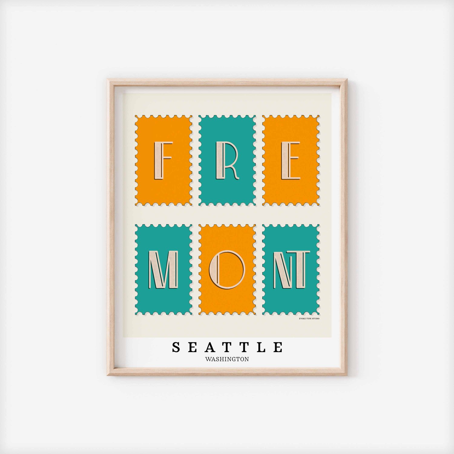 A framed picture of postage stamps featuring the Fremont neighborhood in Seattle, Washington drawn in a unique lettering style. Artwork has a bright blue and orange color scheme