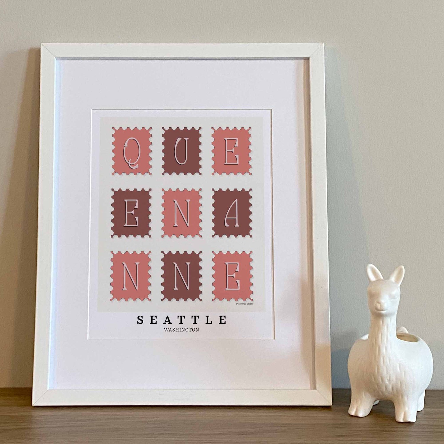 Hand-drawn Queen Anne wall art in postage stamp style featuring unique lettering in pink, burgundy, and white tones