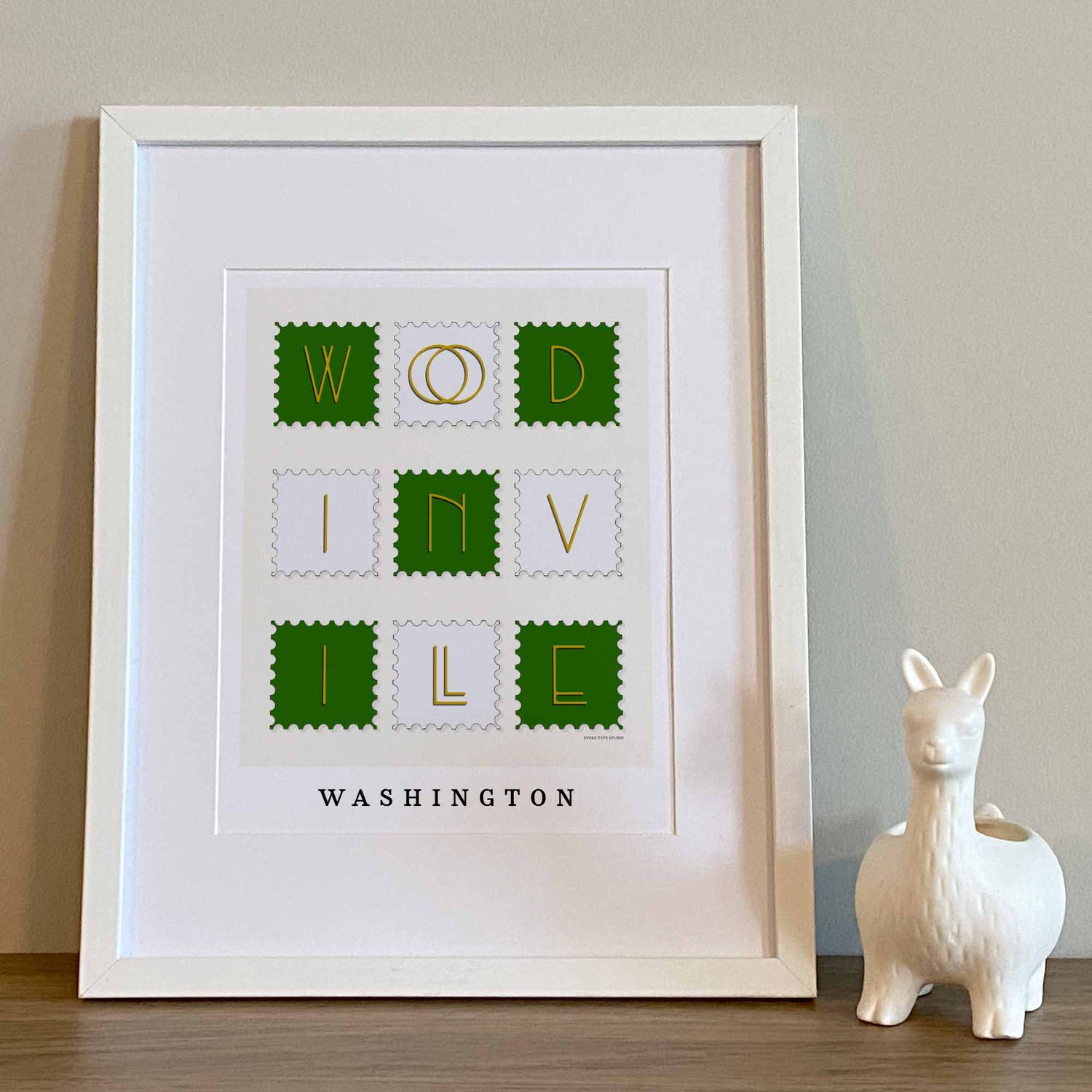 Hand-drawn Woodinville wall art in postage stamp style featuring unique art-deco lettering in green, white, and yellow tones