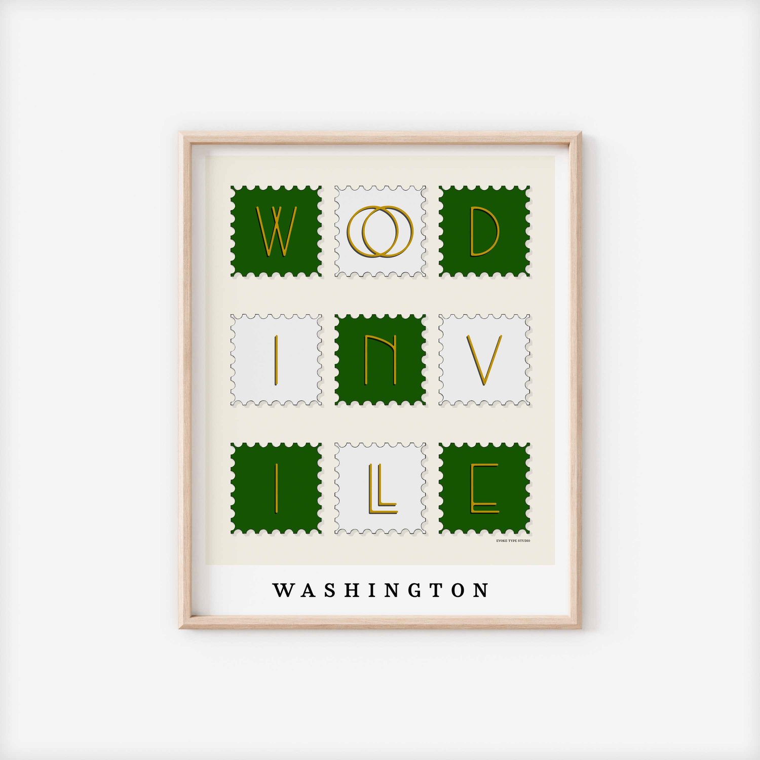 A framed picture of postage stamps featuring Woodinville, Washington drawn in a unique lettering style. Artwork has a green, white and yellow color scheme