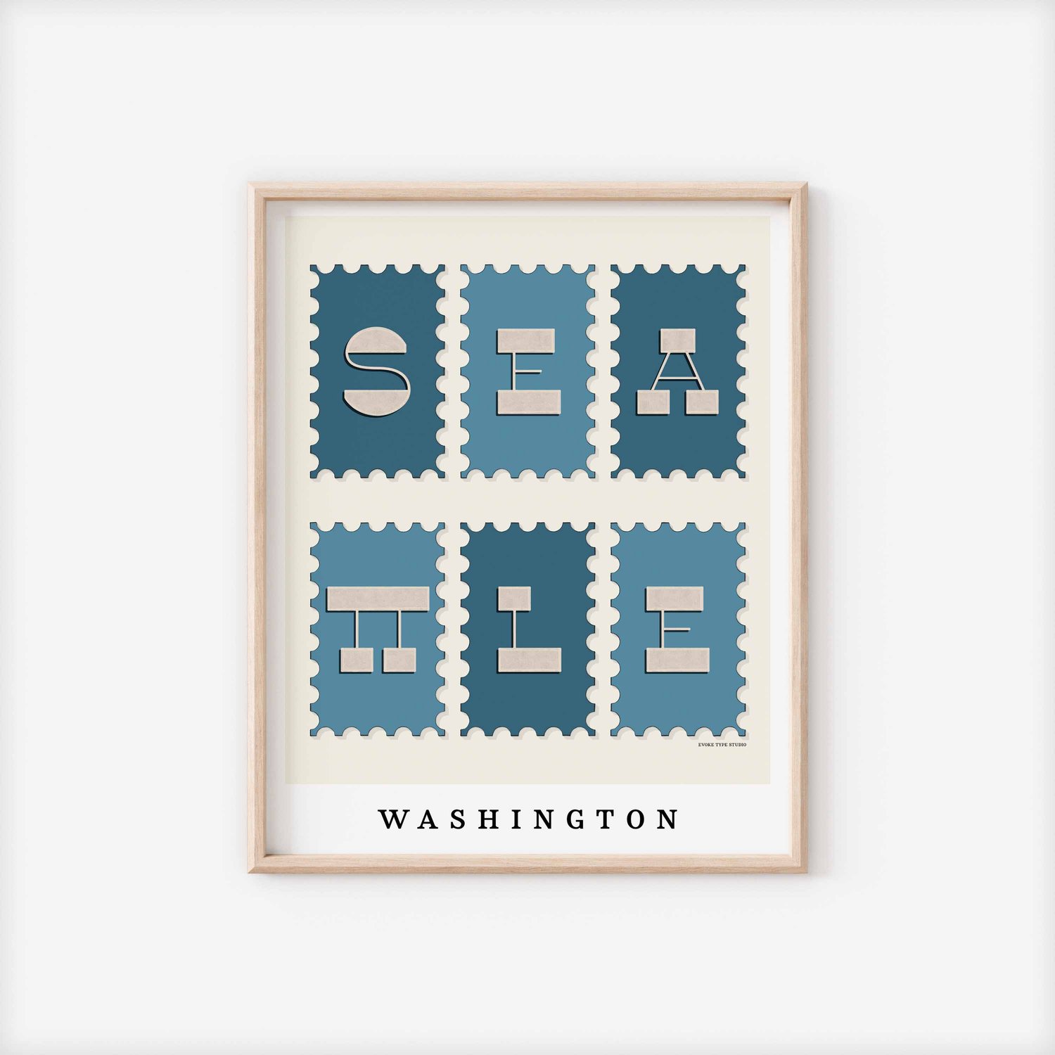 A framed picture of postage stamps featuring Seattle, Washington drawn in a unique lettering style. Artwork has a blue and beige color scheme