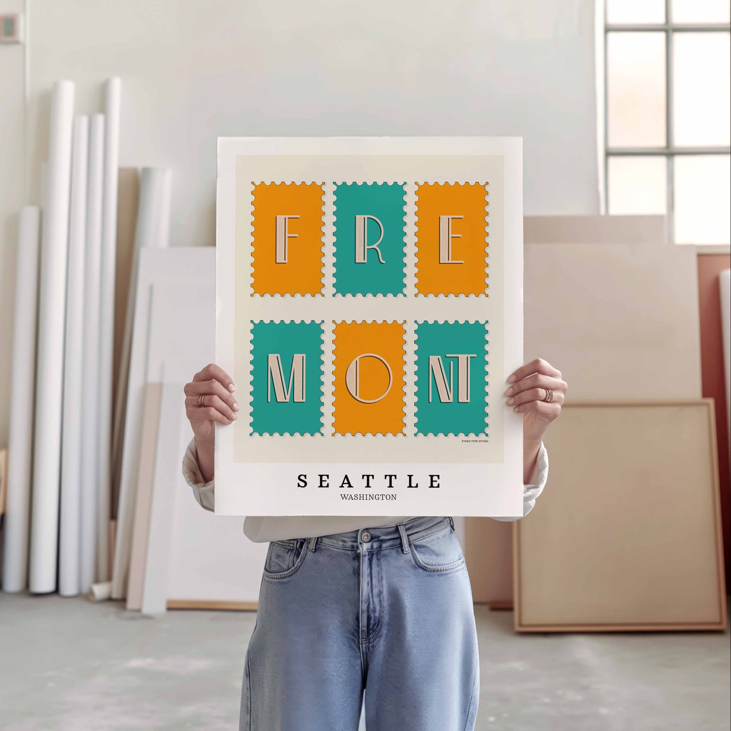 A person holding a poster of several postage stamps
