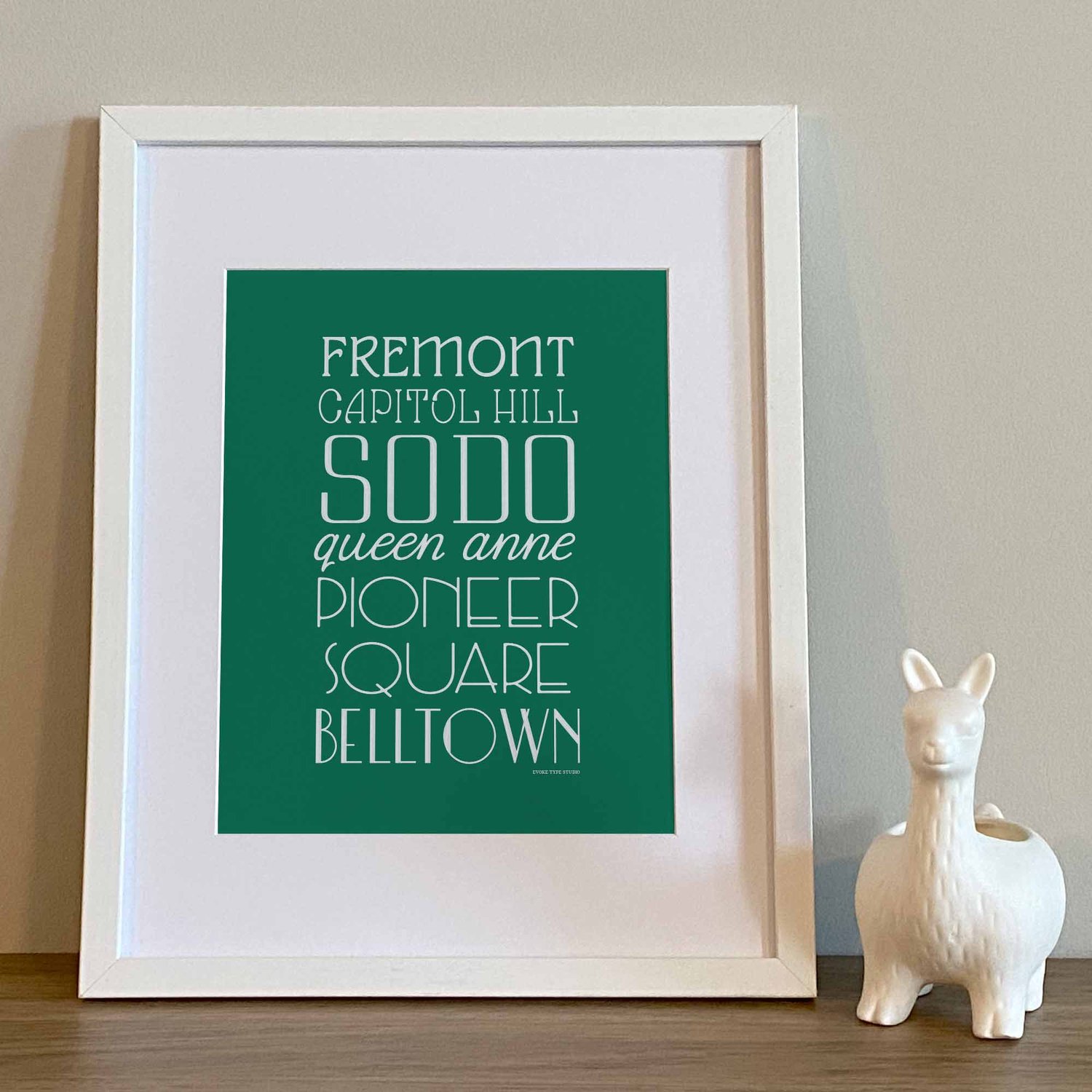 Typography-focused Seattle city print with layered, hand-drawn letters representing multiple neighborhoods
