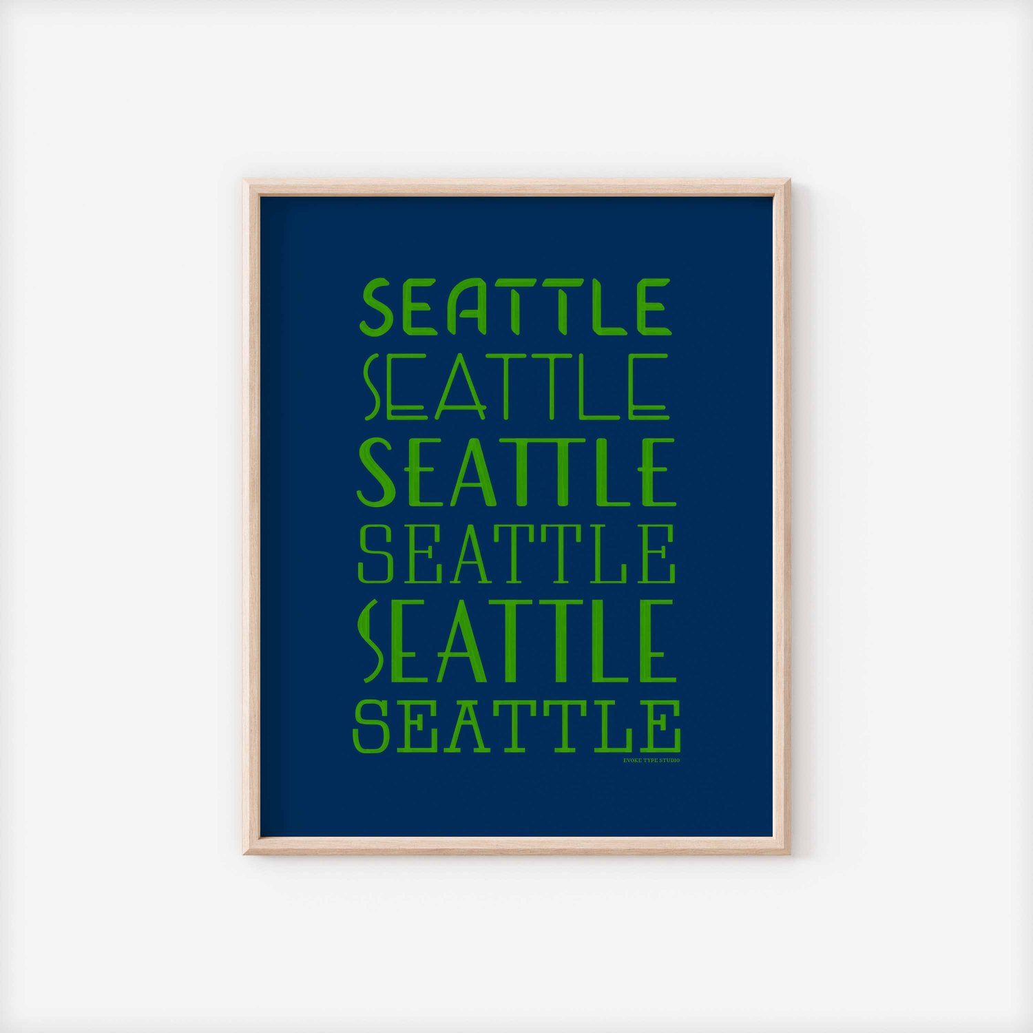 A framed picture of the word "Seattle" drawn in various lettering styles. Artwork has a bright blue and green color scheme