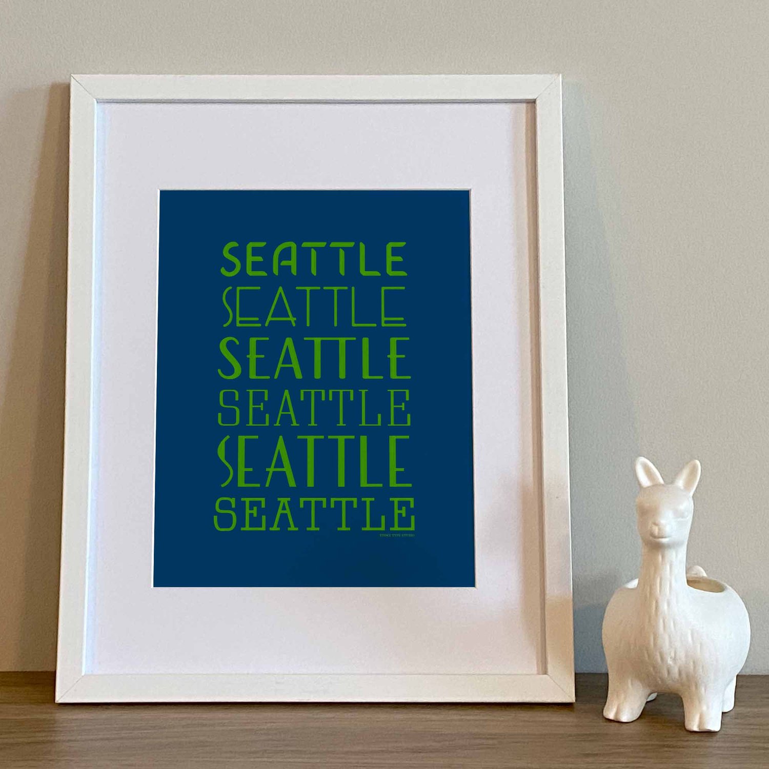 Typography-focused Seattle city print with layered, hand-drawn letters in vibrant blue and green