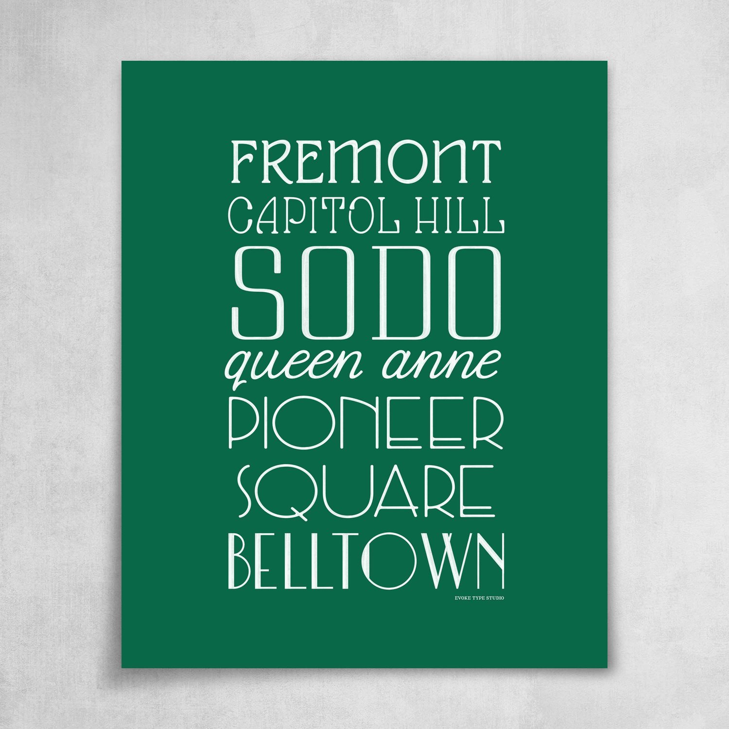 A collection of Seattle neighborhoods drawn in various lettering styles. Artwork has a green and white color scheme.