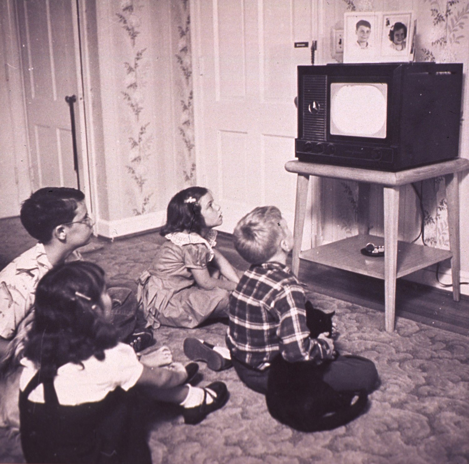 A captive audience of four children watching TV back in the 1950s.
