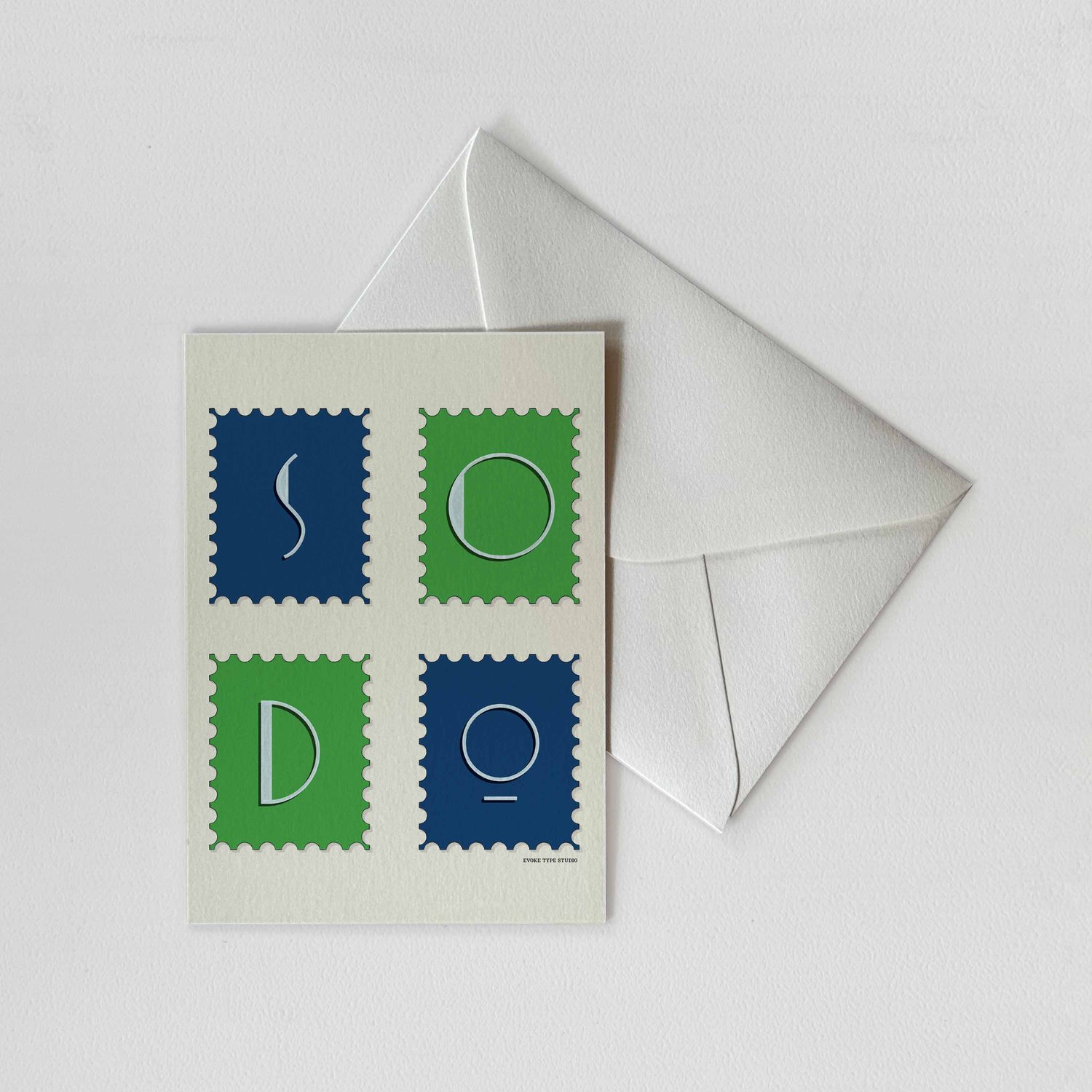 A notecard of postage stamps featuring the SoDo neighborhood in Seattle, Washington drawn in a unique lettering style with a white envelope. Artwork has a bright green and blue color scheme