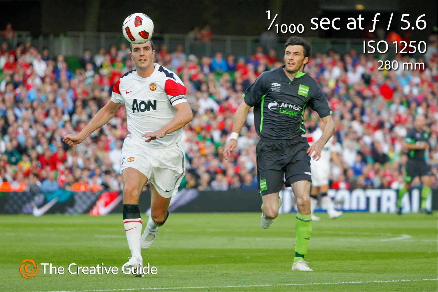 Action shot of a Manchester United player preparing to head the ball during a football match, with opponent close by, photographed at 1/1000 sec f/5.6 ISO 1250, 280 mm, The Creative Guide Photo Gallery.