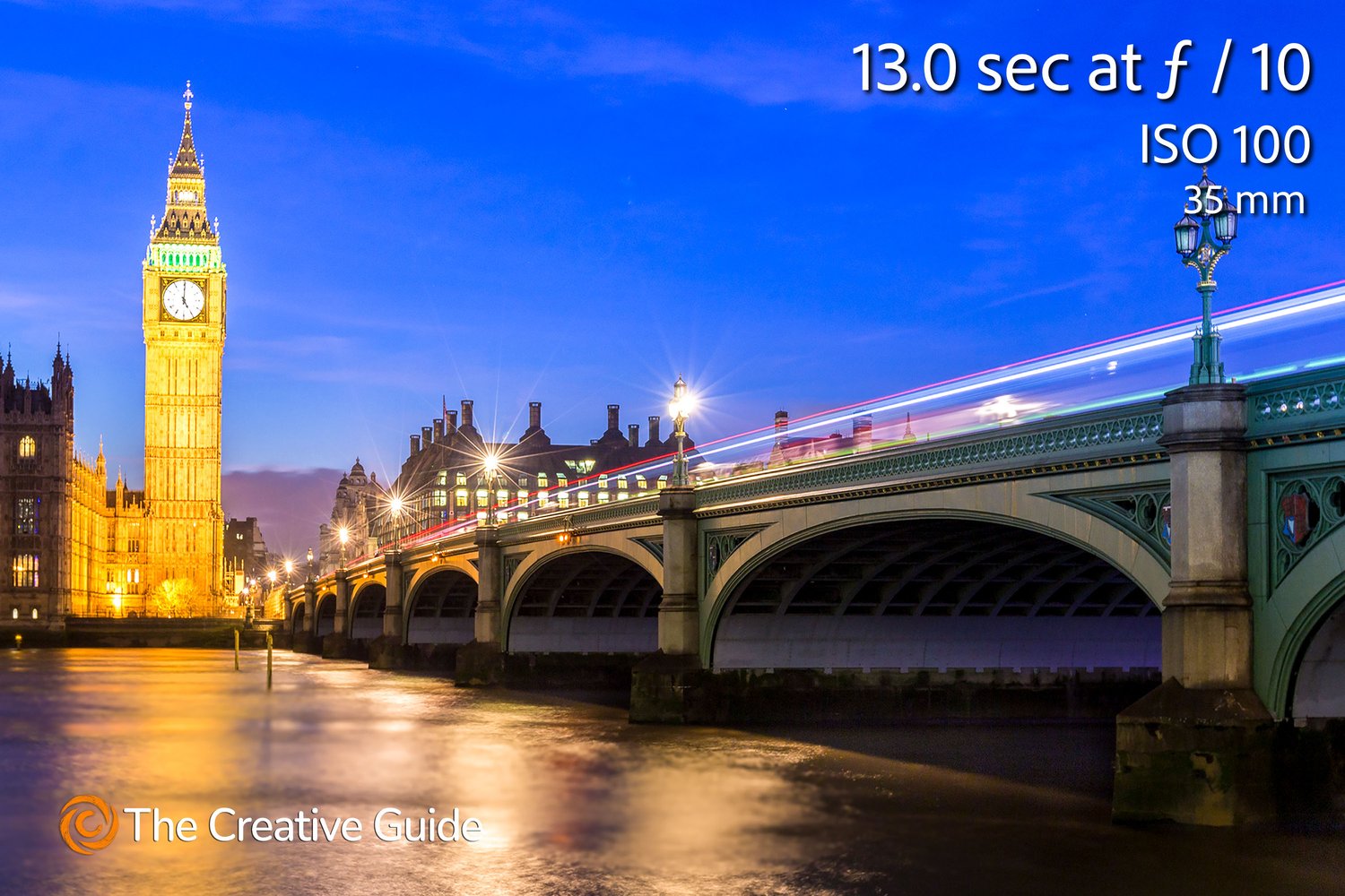 Long exposure photo of Big Ben and Westminster Bridge in London at dusk, smooth water and light trails from traffic, photographed at 13 seconds f/10 ISO 100, 35 mm, The Creative Guide Photo Gallery.