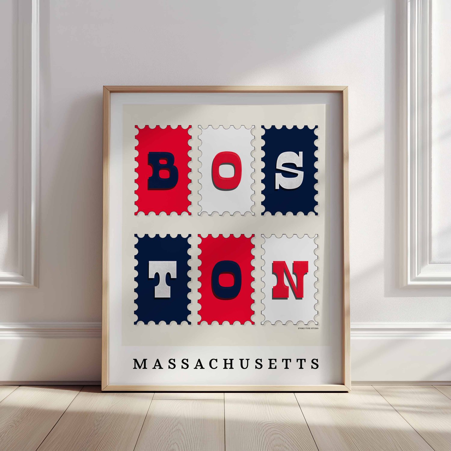 A framed picture of postage stamps featuring Boston, Massachusetts drawn in a unique lettering style. Artwork has a red, white and blue color scheme