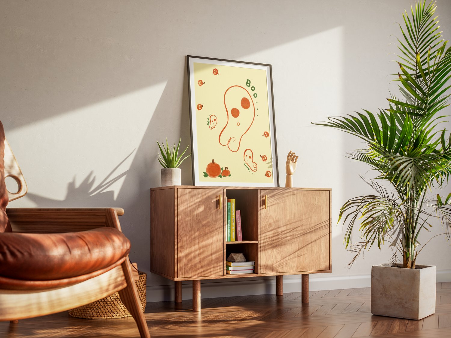 An art print of an abstract, wobbly ghost drawn in orange line art floats against a yellow background. Several smaller ghosts flank the biggest one. Small, abstract Jack-o-lanterns hop around the canvas happily. Two big orange pumpkins with green leaves a