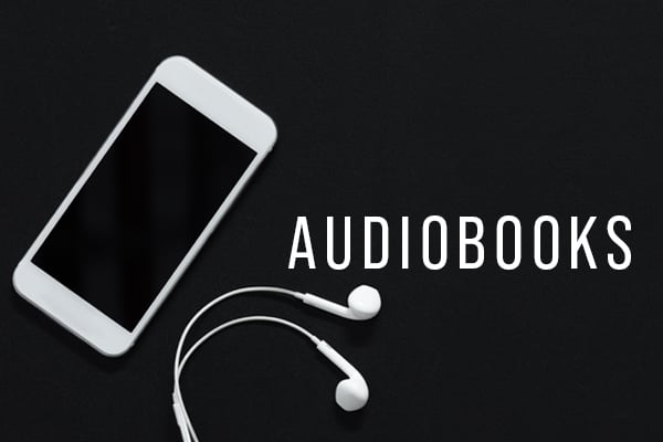 A phone and earbuds against a dark background with the word "audiobooks"