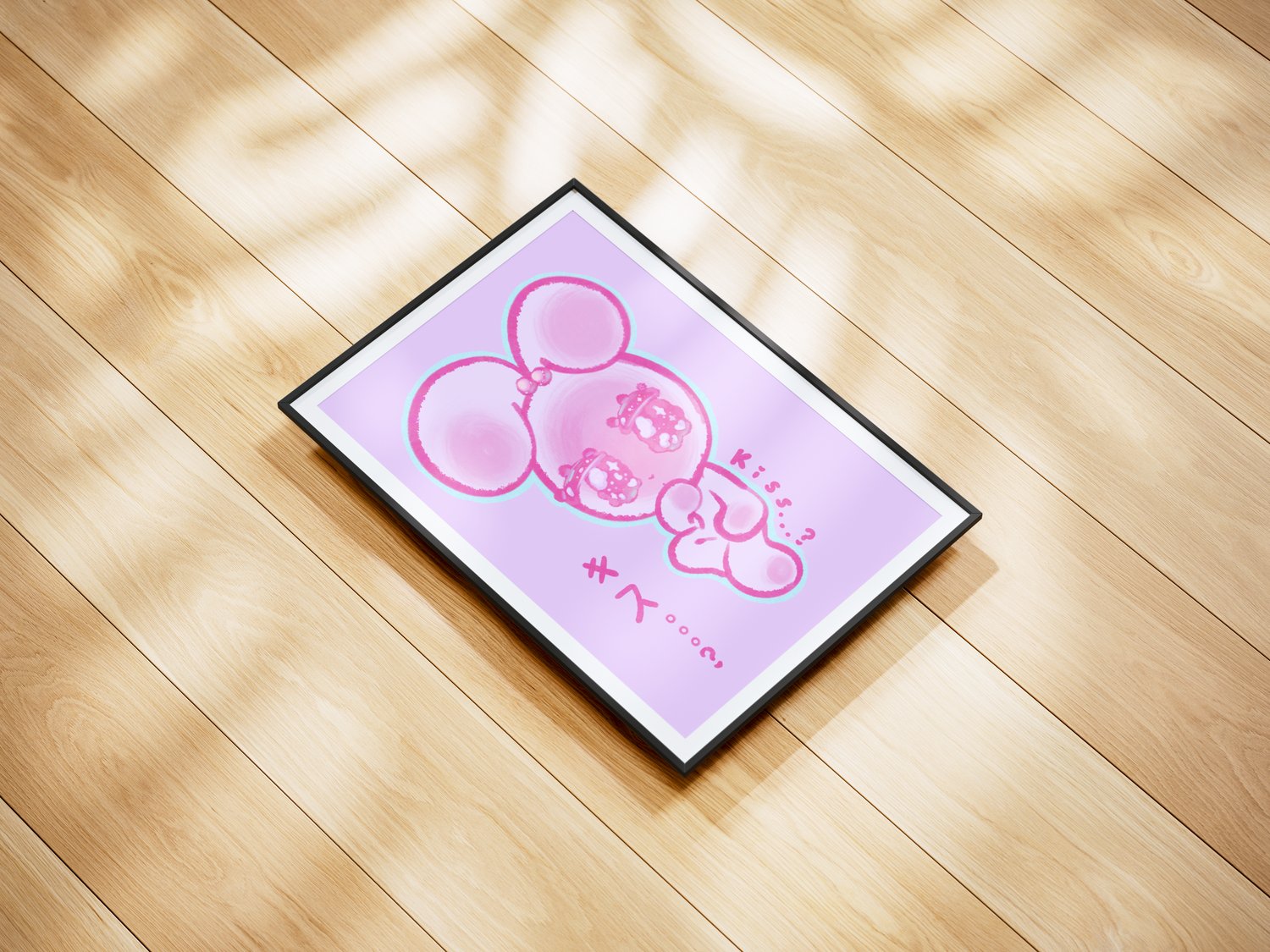 An illustration of a kawaii, white rabbit blushing with big anime eyes. Decorative, pink text in both English and Japanese reads “Kiss…?” The illustration is in a picture frame with a thin black border. It’s viewed from a top-down shot and rests flat agai