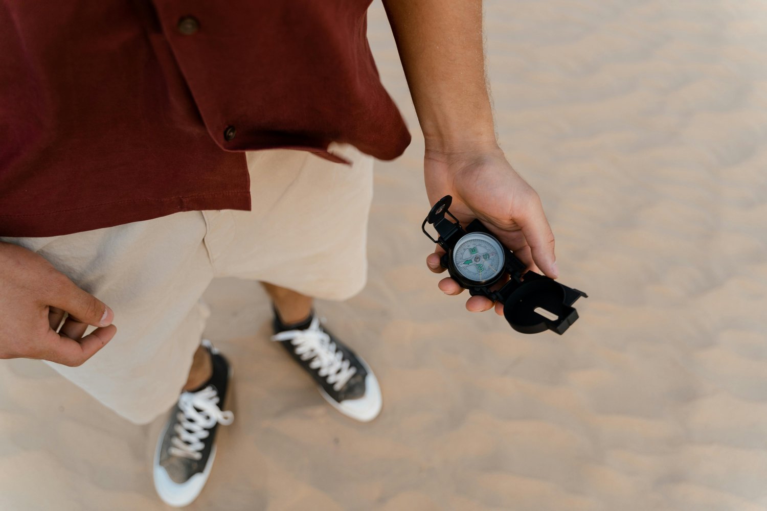 closeup-shot-person-holding-compass