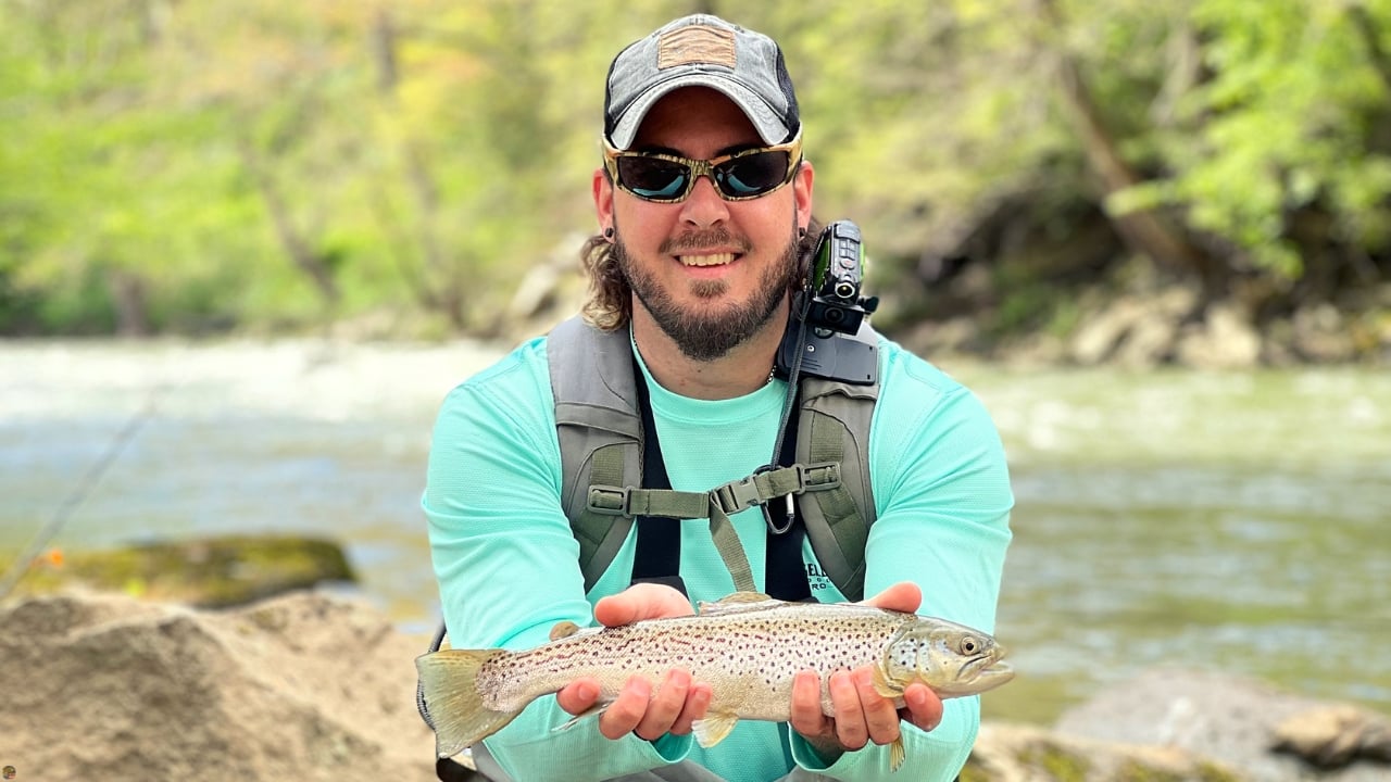 Fly fishing guide Matt Campbell holding a brown trout caught on Maryland’s Youghiogheny River.