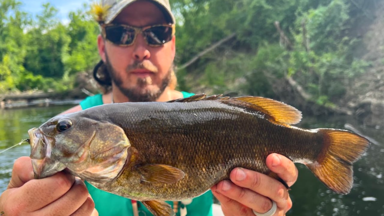 Matt Campbell, The Fly Guy, with a Cuyahoga River smallmouth bass caught on the Creek Bugger Bass Version fly.