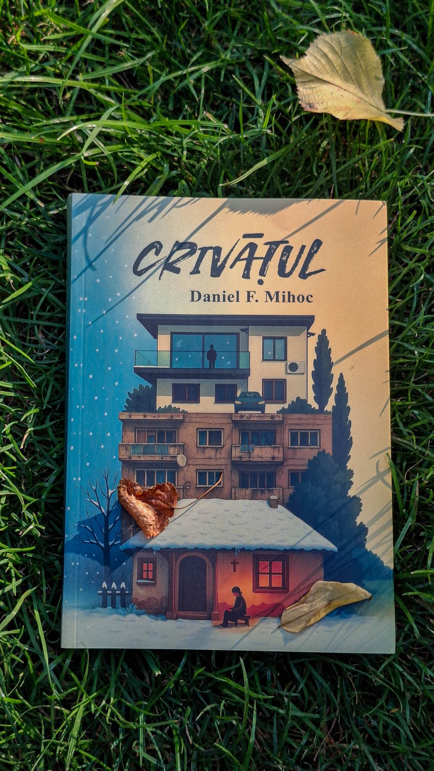 Coperta romanului „Crivățul” de Daniel F. Mihoc, fotografiată pe iarbă